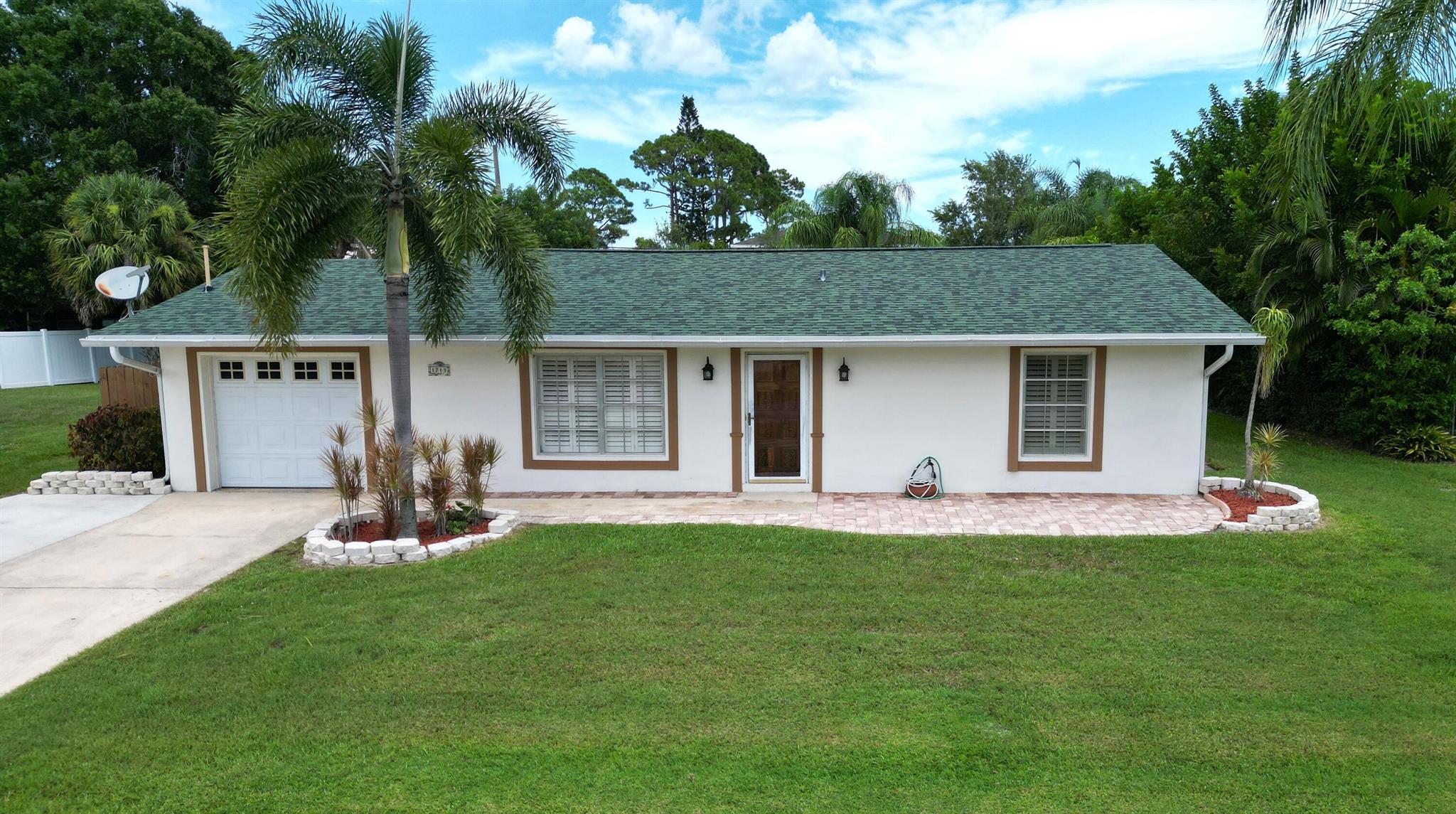 Two Bedroom/Two Bath, CBS, Pool Home situated on a lot and a half! Centrally located in Port St Lucie! New Roof installed 2023! Kitchen, Dining area & Florida Room, all looking out at the Large Fenced in Patio and Freeform Pool! Kitchen has ample wood cabinets with pull out draws. 8'x12' Shed in backyard is included. This house is looking for an owner to give it Love. Bring your imagination and make this home the gem it can be! Room for all your toys. Not many lots this size are available. Don't miss this opportunity!