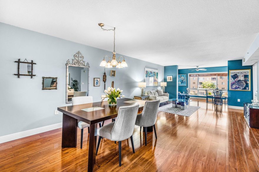 COME SEE THIS BEAUTIFULLY APPOINTED 2 BEDROOM (plus den) 2 BATH ''CHARDONNAY'' MODEL CONDO w/ A BRIGHT & SUNNY FLORIDA ROOM & PANORAMIC LAKE VIEWS!  GORGEOUS CHERRY WOOD FLOORING GIVES THE CONDO AN ELEGANT FEEL.  THE PRIMARY BEDROOM IS VERY SPACIOUS, FEATURES BEAUTIFUL LAKE VIEWS AND A EXTRA LARGE WALK-IN CLOSET. THE PRIMARY BATHROOM FEATURES DUAL SINKS, SEPARATE SHOWER AND A MAKE UP AREA.  THE SPLIT FLOOR PLAN AFFORDS YOUR GUESTS A PRIVATE GUEST SUITE AND THE DEN MAKES A GREAT OFFICE, TV OR FAMILY ROOM. THE SPARKLING BLUE SATELLITE POOL IS STEPS AWAY. CORAL LAKES HAS THE MOST ACTIVE , BRAND NEW & FABULOUS CLUBHOUSE IN THE AREA w/ CAFE/ RESTAURANT, PICKLEBALL & TENNIS, 600 SEAT THEATER FOR SHOWS, MOVIES & ENTERTAINMENT, ART STUDIO, OVER 40 CLUBS TO JOIN OR CARD GAMES TO PLAY, SAUNA & STEAM