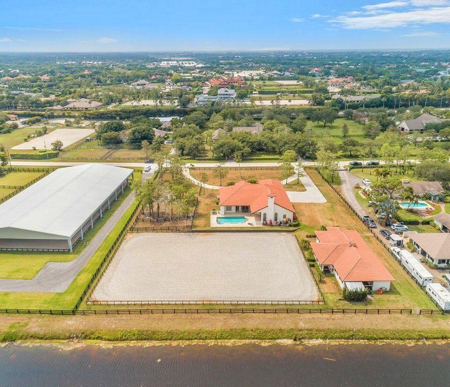 Close in Saddle Trail location can't be beat with a true 12 min. hack to WEF! Beautifully appointed 8-9 Stall CBS barn, complete with exceptional Wordley Martin GGT arena built just 18 months ago! This farm offers all the amenities you need to make your equestrian pursuits easy. The barn features an indoor grooming stall, 2 covered wash stalls, studio w/ full bath, W/D, full sized frig plus separate feed and tack areas. Property's total irrigation system keeps the paddocks green and the arena perfectly set! The lovely 4 bdrm/4 bath home features soaring ceilings, spacious bdrms with a 3-way split plan plus a huge kitchen for entertaining that opens to a large pool patio w/ spa! A massive 4 car garage provides terrific storage for your largest toys and trucks! Room for 3-5 more paddocks.