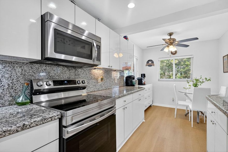 Amazing green garden views from this beautifully maintained corner Magnolia model! Bright, spacious, and tastefully updated, impact windows throughout, vinyl floors, and honeycomb electric shades. Remodeled kitchen with granite countertops, stainless-steel appliances, recessed lighting, a double sink, pantry, and reverse osmosis water system. Enclosed balcony extends the living room, offering additional interior square footage and a perfect space to relax or entertain. Master bedroom with walk-in closet and a remodeled bathroom with a walk-in shower and dual vanities. Newer A/C and water heater, parking space right across from the elevator. Located between 2 pools, close to the Pembroke Road back gate. Association fee covers cable, internet, water, insurance, roof, and all amenities.