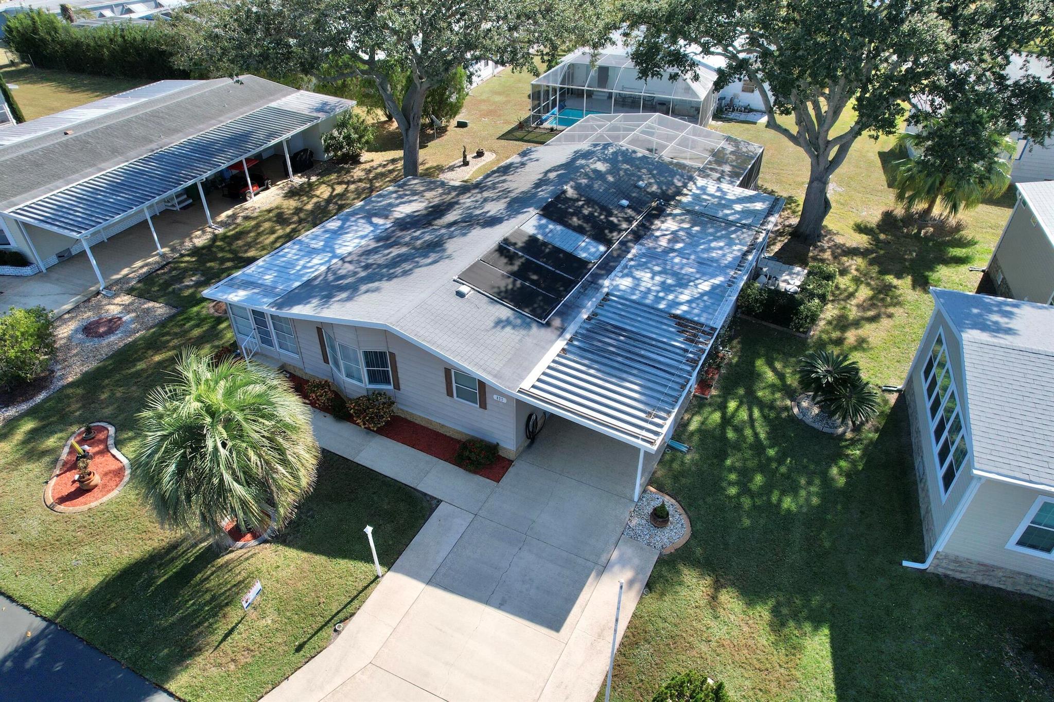 COME HOME TO BAREFOOT BAY.....This 3-bedroom 2 bath pool home is ready for its new owner! Open concept large carport and screened in pool with jacuzzi overlooking the backyard oasis. This home features a third room that can be an office or bedroom. Situated on an oversized lot with a huge shed. Come live the resort lifestyle without the resort fees. This low annual fee, deed restricted community offers 3 community pools, clubhouse, beach access of A1A, and a lot of activities! Come join in the fun!