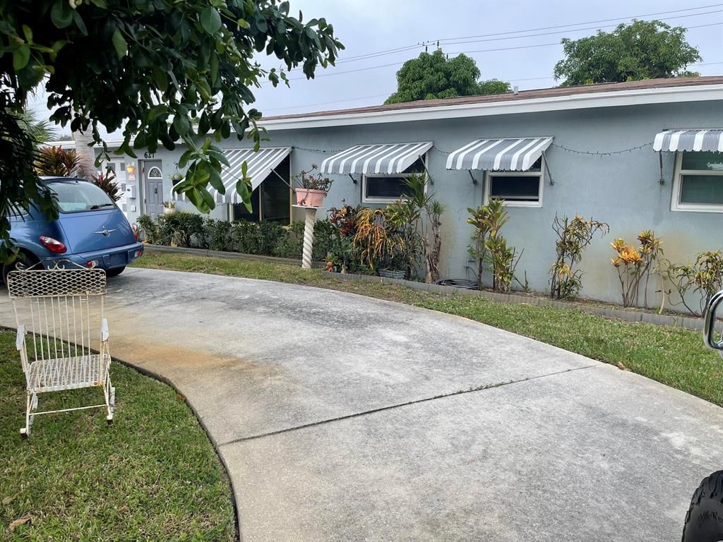 Photo of 627 W Ilex Drive, Lake Park, FL 33403 (MLS # R10849992)