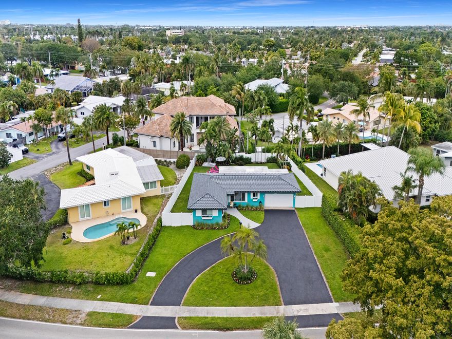 This is a delightful decorator reimagined south Florida home.  All openings are impact. The spacious open floor plan allows for the amazing private fenced yard and pool area to be seen from inside the home.  The hot and cold enclosed shower is very convenient.  Great expense went into redesigning the deck and heated pool. The spacious open remodeled kitchen and new appliances are open  to the surrounding living spaces. Both bathrooms are newly remodeled in a most tasteful manner.  There is a large laundry room and a very generous two car garage. The lot has a 40' deep front right of way from 24 street that gives the home an impactful entrance as well as so much parking.  There are many areas on the property that make this home so easy to expand if your desire. Close to the LHP Marina Additionally new HVAC in 2023, new pool pump in 2024,