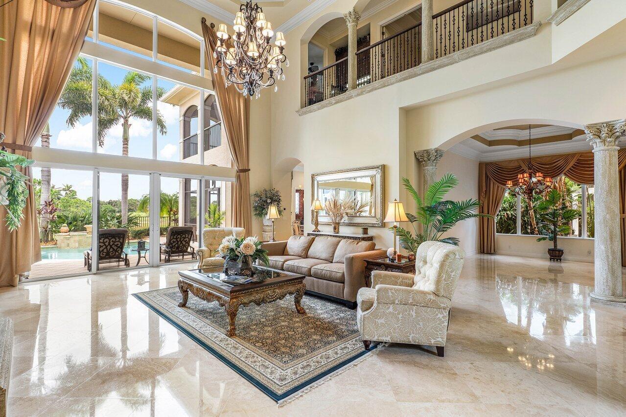 Overlooking the Tesoro River Preserve, this 2-story Custom Creation with 4 bedrooms, 4 en-suite baths, and 2 half-baths features distinctive scenic views of Water, Wildlife, Golf, and a park with moss-draped oak trees. This Spanish Revival home is a breathtaking sight, featuring soaring arched windows and entry foyer, carved wood and stone accents, 24-inch marble floors, natural stone, and abundant molding. Other distinctive details include all luxury brand appliances, a decorative Gas Fireplace, a 2nd-floor media room/Den, upstairs and downstairs laundry, a 3-zone AC system, a Whole-Home Audio System, Instant-on Hot Water, an AC Garage, a 1st-floor wet bar, and a 2nd-level breakfast bar. Enjoy the Beauty of the mature landscaping from the 2 screened-in loggias & a Heated Pool with Spa.