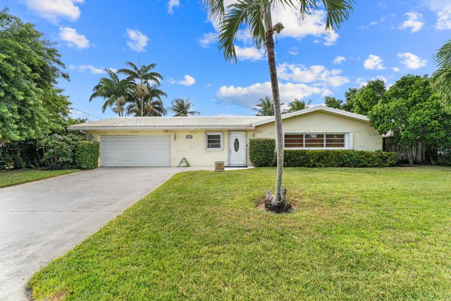 Experience the best of Florida waterfront living in this beautifully appointed 3-bedroom, 2-bathroom home nestled in the highly sought-after community of Lake Clarke Shores. From the moment you walk in, you'll be captivated by breathtaking water views and a bright, open layout that blends comfort with timeless style. This charming residence features plantation shutters, tile flooring, and a kitchen equipped with stainless steel appliances, as well as a sleek cooktop and wall oven, perfect for those who love to cook and entertain. The primary suite offers its own private outdoor access, ideal for an early morning coffee by the water or a refreshing dip in the pool. Step outside to your personal paradise where a private dock, durable metal seawall, and sparkling pool await.