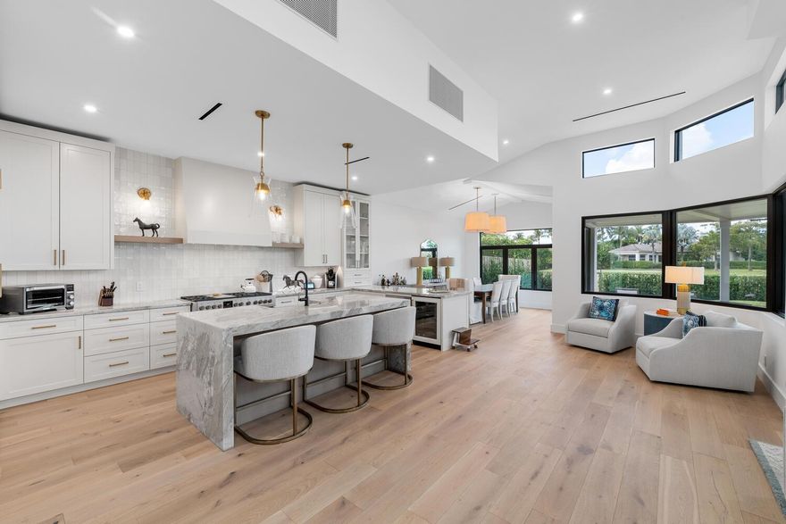 Located behind the manned security gate of the exclusive Palm Beach Polo Country Club. This stunningly renovated 3-bedroom, 3-bathroom home offers a blend of modern elegance and functional design, all while overlooking the picturesque Cypress Golf Course and featuring a serene lake view. With its open floor plan, high ceilings, and wood floors throughout, this home exudes both style and comfort. The kitchen is a chef's dream, showcasing custom cabinetry, marble countertops, and a farmhouse sink. It comes fully equipped with all new appliances, including a gas range and a Fhiaba refrigerator. The attention to detail extends to the sleek plumbing fixtures and new HVAC unit with stylish lineal AC vents installed in the ceiling.