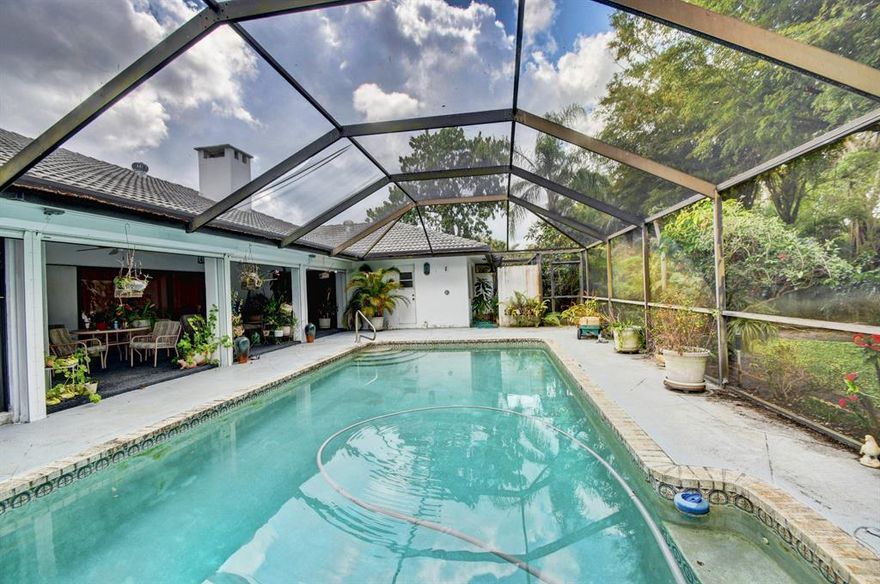 Enter your future oasis in a 24-hour manned gated private golf course community. With Beautifully landscaped gardens and privacy, every room is over-sized including all 4 bedrooms, 3 bathrooms, vaulted ceilings, family room, dining and living room, indoor large laundry room, 2+ car garage and amazing open flow throughout the home. Bonuses : indoor air-conditoned 'summer kitchen' that leads to your pool area for effortless entertainment for kids, family and friends. 100 gallon generator. Large covered porch and screened-in pool. Interior needs TLC. Great opportunity to buy into popular Pine Tree Golf Club at a great price. Price per square foot is invaluable. Make it your own.