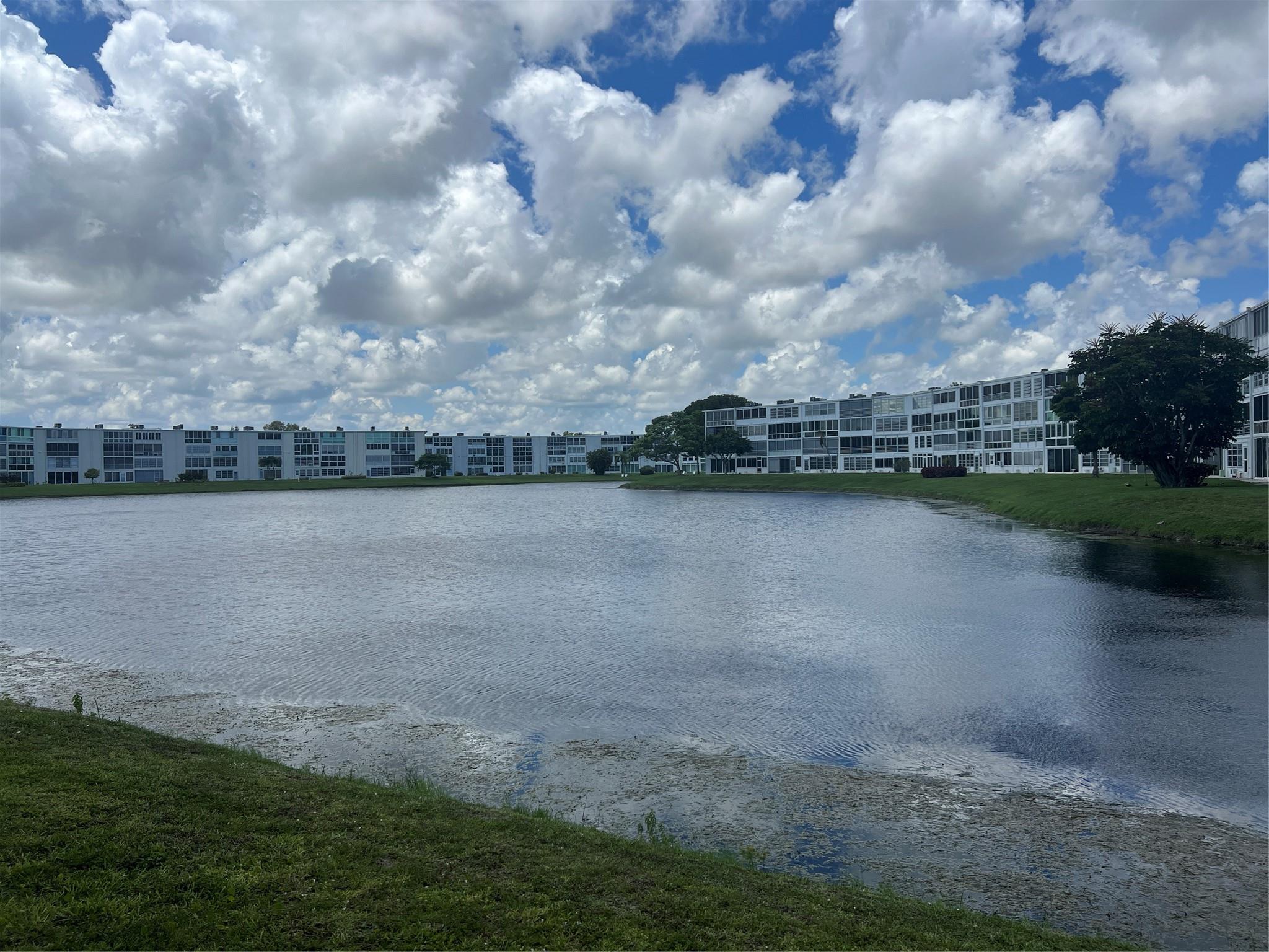 Gorgeous Lake view Building 2 bedroom 1 1/2 bath condo in Century Village. Seller Motivated!!! New refrigerator and electric range, new carpets in the bedroom. Master bedroom has a walk in closet with closet organizers. Bathrooms feature new vanities and a walk in shower. Enjoy a cup of coffee on your enclosed balcony while over looking your beautiful lake view. This is the perfect condo to enjoy the Florida winters. Century Village offers an indoor and outdoor swimming pool for your enjoyment. Amenities include Clubhouse, Pickleball Courts, Tennis Courts, Fitness Center, Billiards Room, Theater and Courtesy Bus for your convenience.