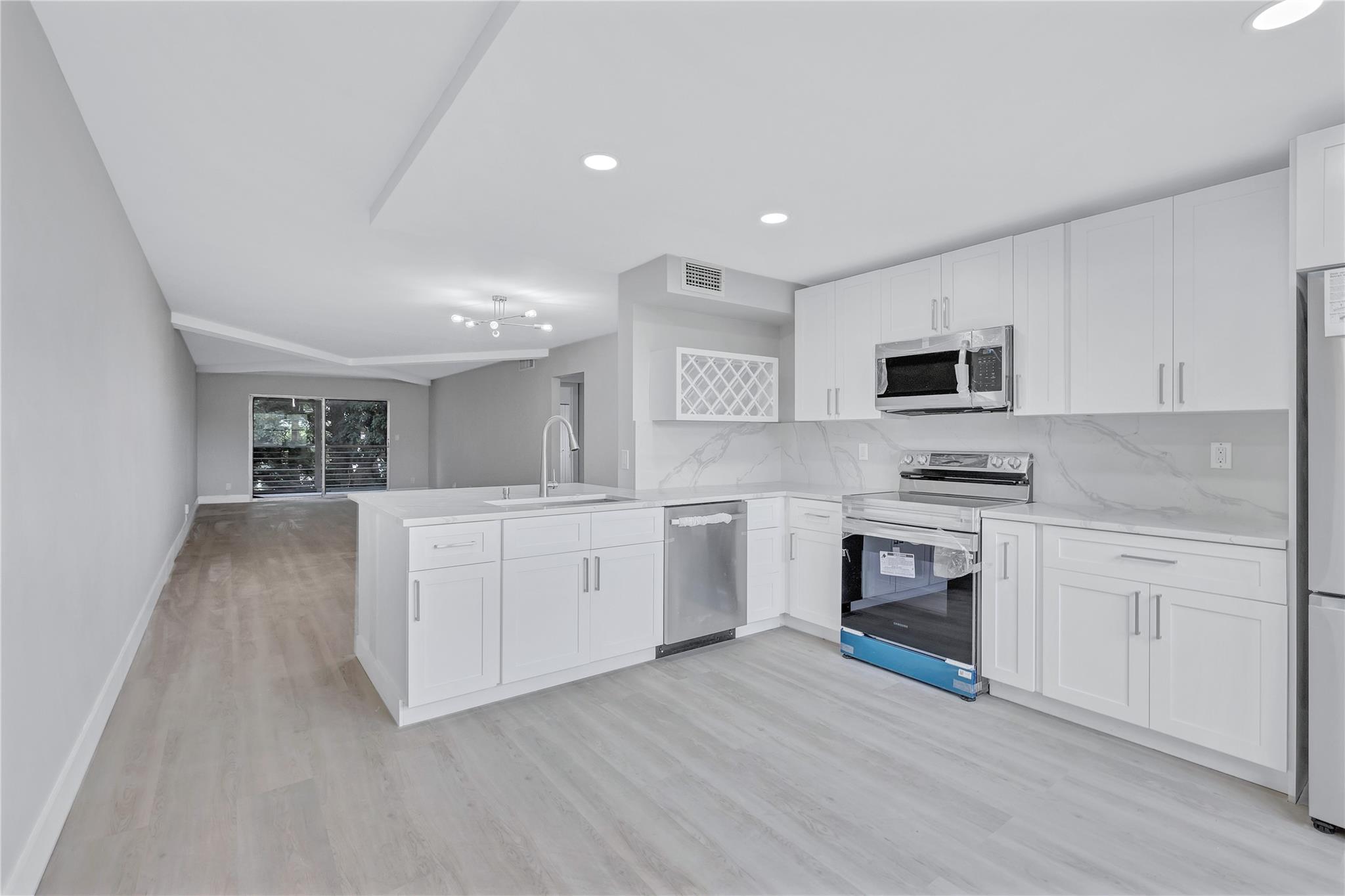 Beautifully remodeled 2/2 condo in Wynmoor. New AC, new water heater, new stainless steel appliances. The open kitchen has brand new white cabinets and quartz countertops. This stunning condo spared no expense. You’ll enjoy luxury vinyl flooring throughout the home. The bathrooms feature large format tile to ceiling, as well as new vanities & flooring. Wynmoor is a gated active adult community that offers a plethora of activities, such as pools, tennis, pickleball, theatre and much more.