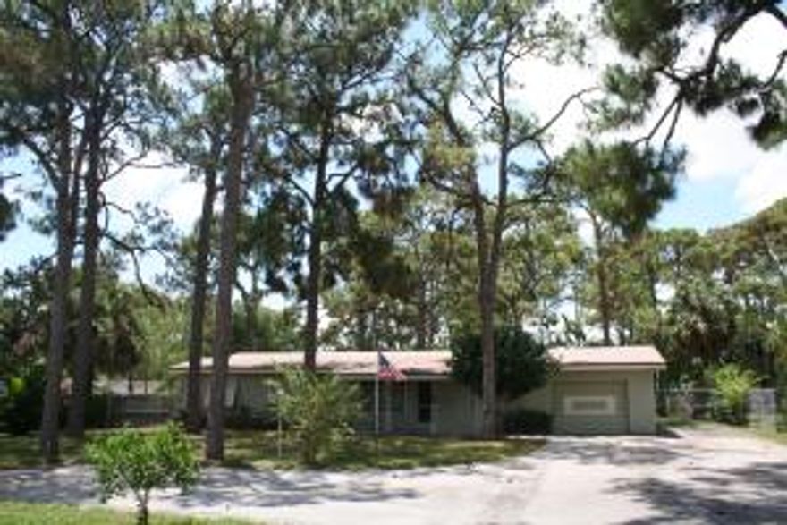 Great location with almost 3/4 acre (.74) in town. Newer roof, open kitchen, bright enclosed Florida Room. Bring your RV, trailer, boat, trucks, toys and pets! No HOA and plenty of parking with a 2 car garage, cement slab, extra large driveway and fully fenced back yard. Property has city water and is zoned Multi-Family (Medium Density) so can add additional buildings if desired. Great schools, close to shopping, highways and airport.