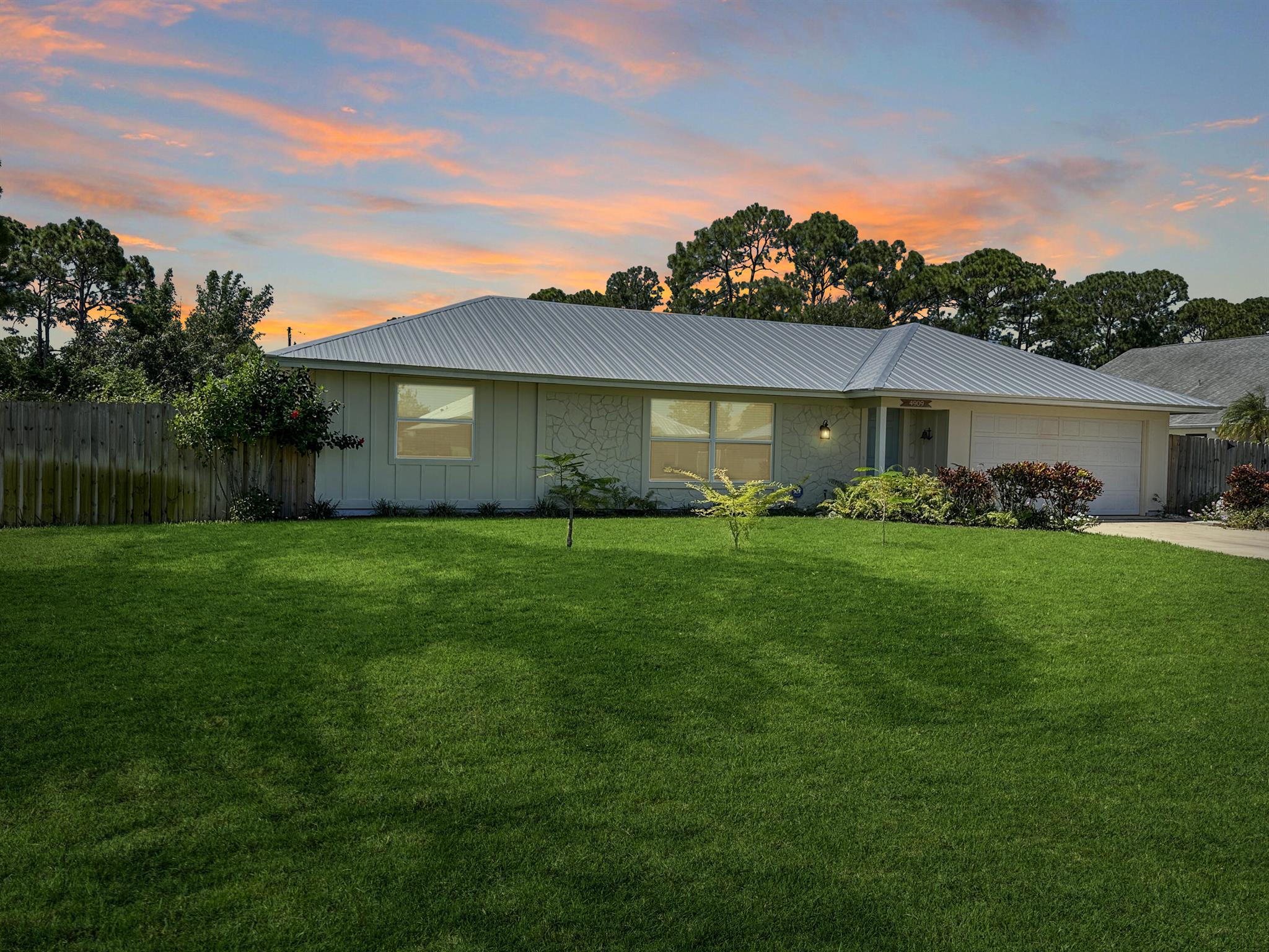 Discover the epitome of Florida living in this stunning single-family residence nestled in the sought-after Holiday Pines Community. Boasting three bedrooms and two elegantly remodeled bathrooms, this home offers both comfort and style. Step inside to find a beautiful, remodeled kitchen complete with newer appliances and a walk-in pantry, along with a separate living room and family room for versatile living spaces. The spacious master suite features an updated bathroom with a tiled shower, large vanity, and a custom walk-in closet.The generous dining area overlooks a serene pool with new screening, providing the perfect backdrop for gatherings or quiet evenings. The large backyard is a private oasis, featuring a wide variety of fruit trees and backing up to a canal, ensuring privacy