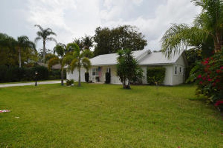 Discover this move-in ready, 3/2 home on a large corner lot in desirable Jensen Park Estates with fenced yard, covered patio & room for a pool. Open plan with vaulted, cathedral ceilings, newer guest bath, some impact glass replaced windows. Split bedroom plan with newer flooring n guest bedrooms. Generator and hook-up. Most of the 2 car garage is currently converted to air conditioned hobby room. Seller will convert back to garage if buyer desires. Only 4 mins to Jensen Beach Elementary School & 9 mins to ''A'' rated Jensen Bch High School. Very close to downtown, shopping, restaurants, medical & churches, beaches. Easy to see.