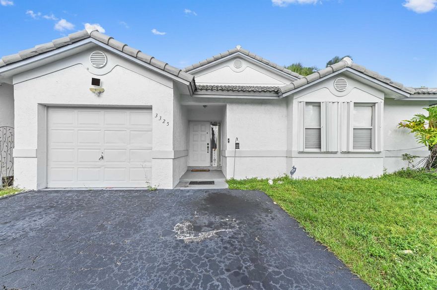 Welcome to this charming single-family home, perfectly situated in the heart of Davie, offering a bright and spacious living experience. This residence features a fantastic open-concept floor plan with vaulted ceilings, creating an inviting and airy atmosphere. The living and dining areas are complemented by stylish wood-look laminate flooring that flows seamlessly, while a kitchen with pristine white cabinets and appliances is ready for all your culinary needs. The home is a fantastic canvas for a buyer to personalize and make their own.