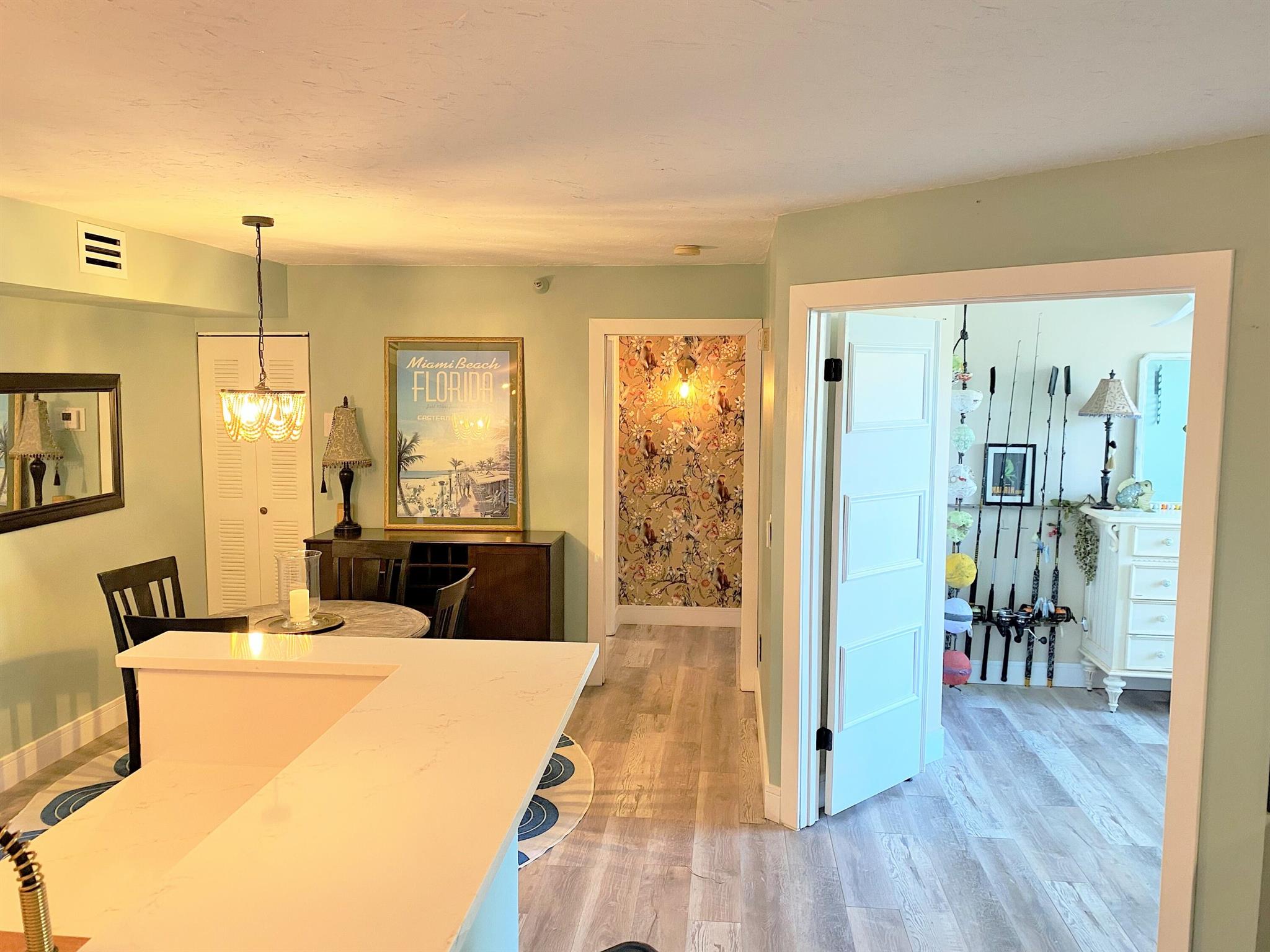 Stylish Corner Unit in a highly sought after Intracoastal Waterfront Community. Enjoy coastal living in this refreshed corner-unit condo with a first-floor private entry. The kitchen features quartz counter-tops and black stainless steel appliances with spacious laundry/pantry area complete with pantry cabinet and additional beverage refrigerator and storage shelves. Main living areas have luxury vinyl wood plank flooring throughout, private patio with a trendy green wall perfect for relaxing while overlooking the brand-new pickle-ball/tennis courts.Set in a pet-friendly, all-ages community, residents enjoy resort-style amenities: waterfront pool and clubhouse, pickle-ball, fitness center, waterfront tiki hut-BBQ area, theater room, dog park, onshore fishing area, plus Marina.