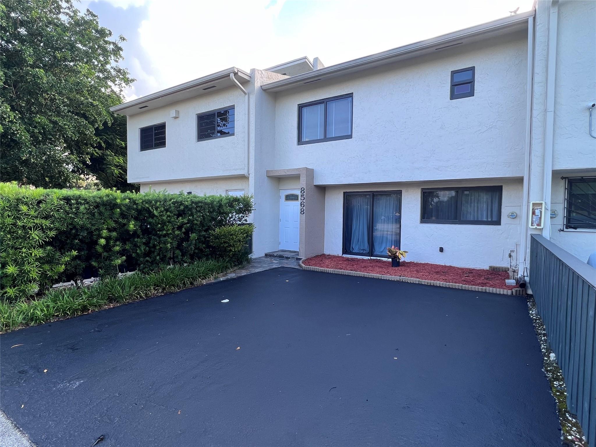 Huge 3-bedroom townhome with private driveway, large patio and vaulted ceilings. Completely remodeled from head to toe with very nice finishes including modern bathrooms, quartz counters, porcelain tile floors throughout and impact windows + doors. Very easy to show