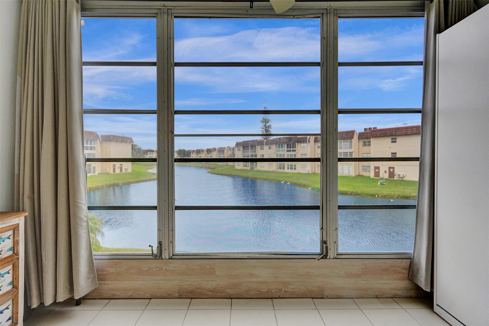 Discover your dream home in Sunrise Lakes. This beautifully updated unit features 1 bedroom and 1 bathroom, with stunning lake views. Highlights of this home include an updated kitchen and bathroom, stainless steel appliances, laminate and ceramic tile flooring, and an enclosed patio. Murphy bed on enclosed patio is the perfect place for guests. Internet and cable are included in the monthly fee. This unit comes fully furnished, making it move-in ready. See this incredibly well-kept unit with the best lake view in the community today.