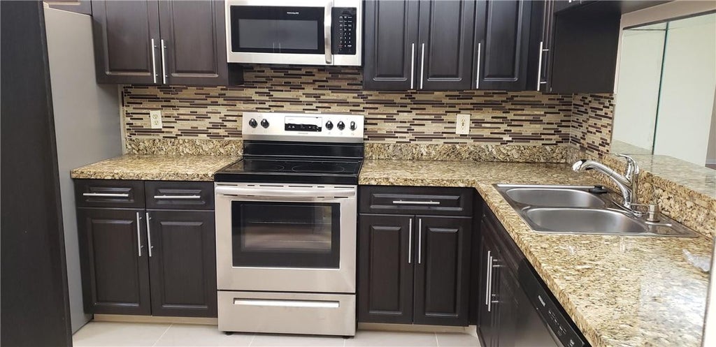 Photo of 7050 NW 44TH Street #403, Lauderhill, FL 33319 (MLS # B26065387)
