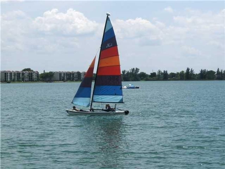 Look no further! 2/2 condo sits at the edge of a 168 acre pristine lake! Tiled floors, open kitch., split br plan, w/d in unit, screened balcony with expanded views of the water. Corner unit, immaculate condition. 24 hr. gated community has 3 heated pools & spas, tennis cts, fitness center and much more. Premium cable tv incl.in condo fee. 2 sm pets OK. Low down OK as condo has great reserves! Beautifully maintained community with lots of open space. You'll love it here!