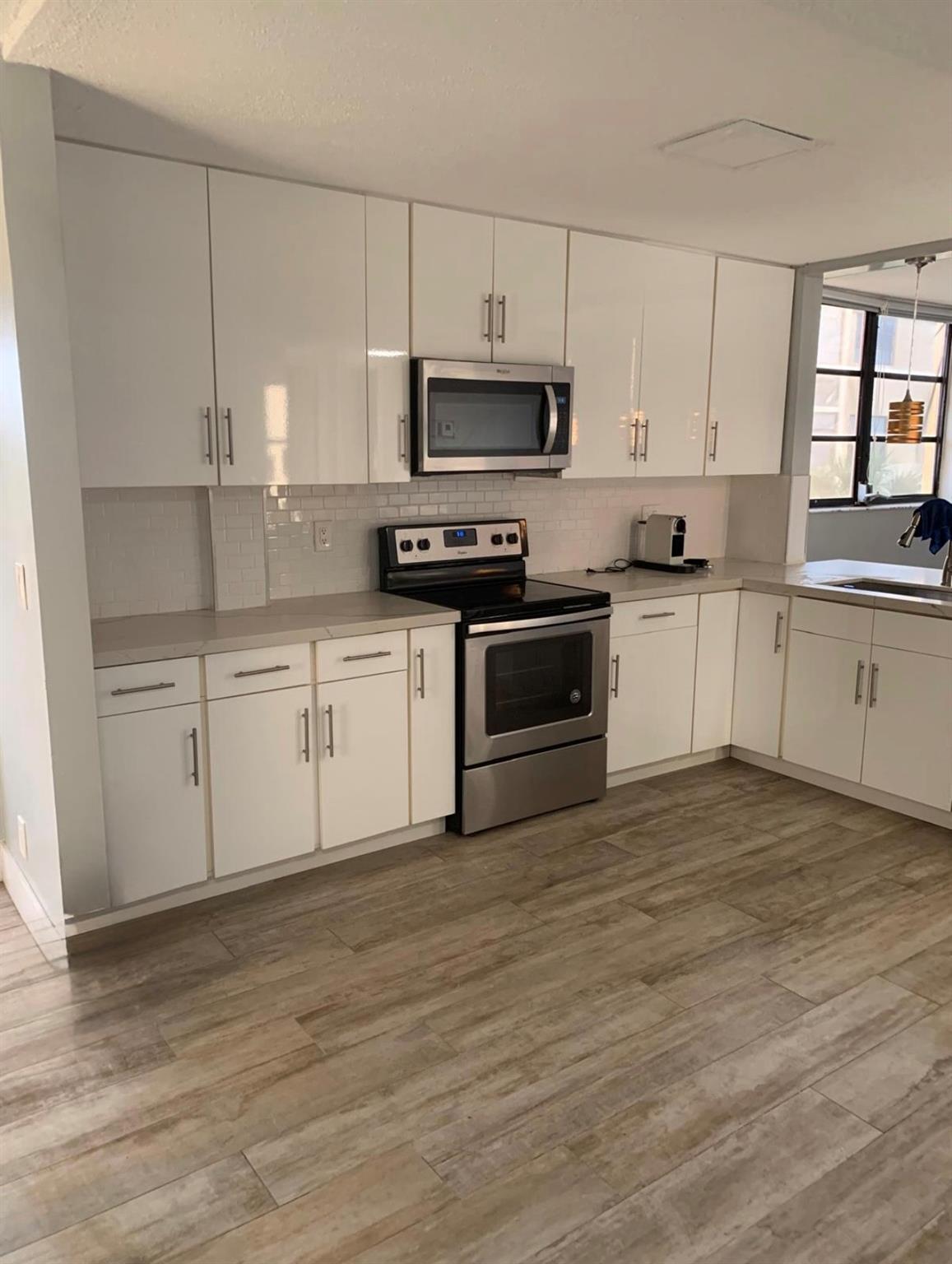 BEAUTIFULLY RENOVATED 2BR, 2BA CONDO. SPACIOUS CORNER LOT AND OPEN FLOOR PLAN! Step into comfort and style in this corner lot condo featuring a bright and airy open floor plan. It offers seamless flow between the kitchen area, dining room and living room, perfect for modern living and entertaining. The spacious kitchen boast ample cabinet space, a large pantry and stainless steel appliances. Both bathrooms have been tastefully remodeled. The primary bedroom is very roomy and has a large walk in closet with built in cabinetry. Another great feature is the front load washer and dryer for your convenience. Enjoy the privacy and space that comes with the corner lot, plus the location nearby shopping, dining and major roadways. This move in ready rental is a must see!