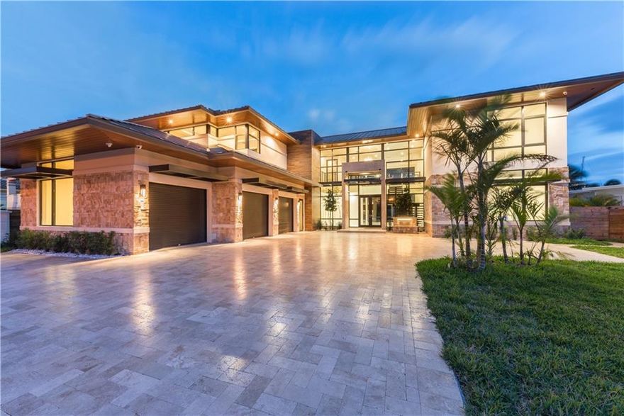 This Stunning Contemporary Yet Warm Masterpiece Has 83' Of Deep Water Frontage On The Beautiful Expanded Seminole Turning Basin. Impeccable Design Elements Of Stone, Glass, Steel & Wood Create A Spectacular Blend Of Traditional, Modern & Tropical Architecture. A True Boat Enthusiast's Paradise w/4 Boat Docks Accommodating Two 80' & Two 70' Yachts, & 4x50 Amp Power. Elevator, fireplace, metal roof.