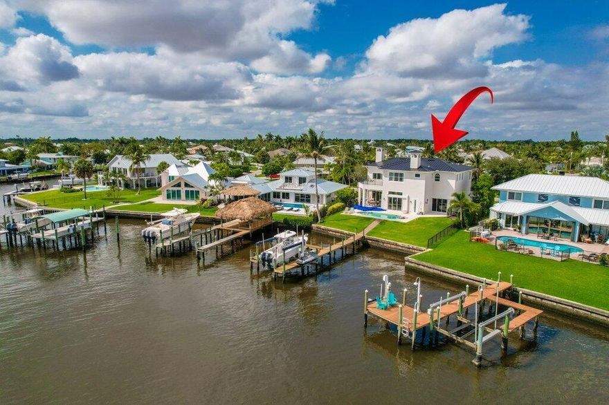 Welcome to an exceptional waterfront residence in the heart of Palm City, offering sweeping wide-water views, direct ocean access with no fixed bridges, and a luxurious indoor-outdoor lifestyle designed for year-round enjoyment.Set along the scenic St. Lucie River, this newer construction home has been extensively upgraded with a brand-new roof, hurricane-impact windows and doors, and a fully remodeled designer kitchen with quartz countertops, custom cabinetry, and new appliances.Step outside to your private backyard oasis featuring a resort-style pool, covered patio, and lush tropical landscaping--perfect for entertaining or quiet riverfront relaxation.