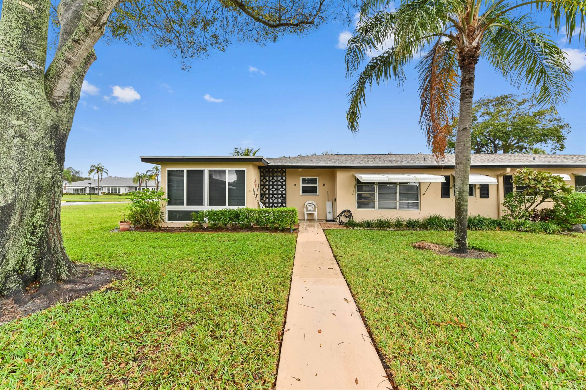 Presenting 1060 North Dr, a luminous and spacious offering in the desirable High Point of Delray, an active adult community. This property exemplifies secure, low-maintenance living with its entire structure protected by impact glass windows, contributing to the longevity of the home and peace of mind for the occupants. Setting foot inside, you are met with an open-concept floor plan that distributes an abundance of natural light, creating a serene and inviting atmosphere. An elegantly renovated open kitchen is at the heart of this home, fitted with custom wood cabinets and stylish granite countertops. This optimal space invites culinary creativity while serving as a social hub of the residence.