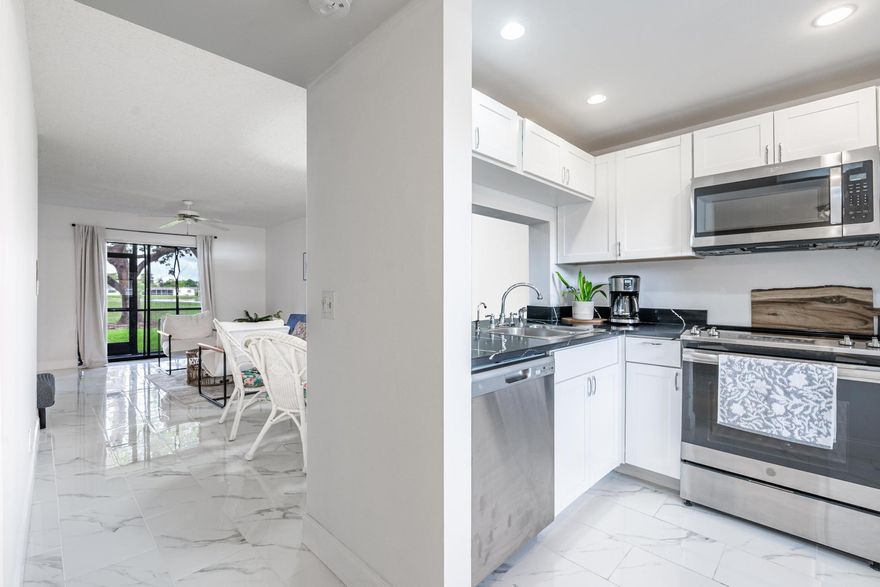 Welcome to your dream condo offering an idyllic lifestyle with exceptional amenities and convenience. This 55+ 2 bed 2 Bath 1st Floor residence is a corner unit with a screened patio overlooking both lake & golf course. 
The renovated kitchen with stainless steel appliances and granite countertop has windowed layout for natural light. Gorgeous white porcelain tile floors flow effortlessly throughout the living spaces, & the closets provide ample storage. NEW Water Heater, Central AC, In-Unit Washer/Dryer, and assigned & guest parking offer a seamless blend of comfort & convenience. The array of community amenities include: clubhouse, gym, basketball court, tennis court, putting green, shuffle board, &  billiards room, perfect for social gatherings or unwinding after a long day.