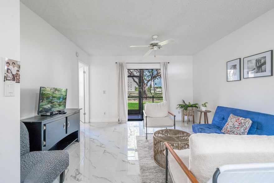 This 2 Bed, 2 Bath 1st Floor corner unit residence with screen patio in Sunrise Lakes Phase 4 (55+ Community) overlooks the lake & golf course. The renovated kitchen with modern appliances and granite countertop has a windowed layout and flows seamlessly into the the living and dining area. Beautiful modern white porcelain tile floors flow effortlessly throughout the living spaces, & the closets provide ample storage. New Water Heater, a Central AC, In-Unit Washer/Dryer, and assigned & guest parking offer comfort & convenience. Community amenities include: clubhouse, gym, basketball court, tennis court, putting green, shuffle board, &  billiards room - perfect for social gatherings or unwinding with friends and family after a long day.