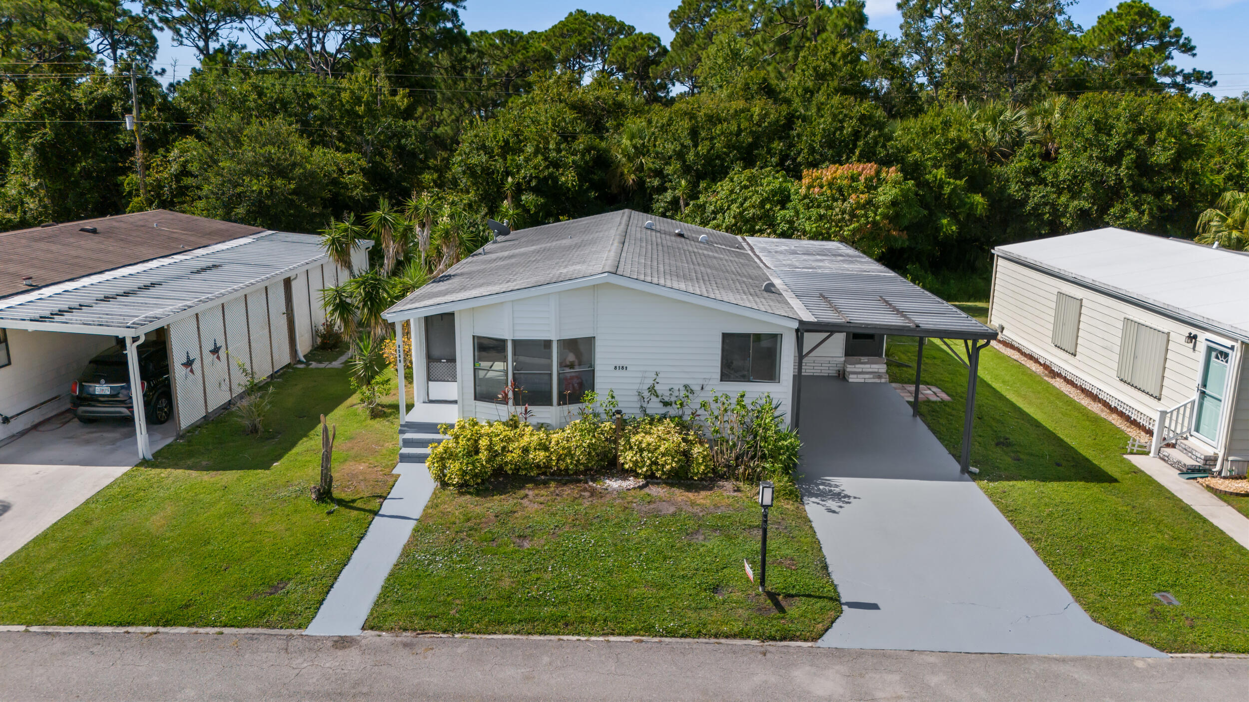 This exquisite residence boasts ample space and is situated within a desirable community, complete with pool, clubhouse, and welcoming neighbors, Having undergone recent renovations, the property features freshly painted walls, a brand new kitchen equipped with appliances, cabinets, and countertops. Additionally, it showcases new flooring and upgraded bathrooms with modern vanities. Conveniently located in close proximity to shopping centers, beaches, malls, and more, To arrange a viewing, Please schedule an appointment or access the listing via SHOWTIME. please note that this property requires a monthly lot rent of approximately $600, which encompasses basic cable and garbage collection services.