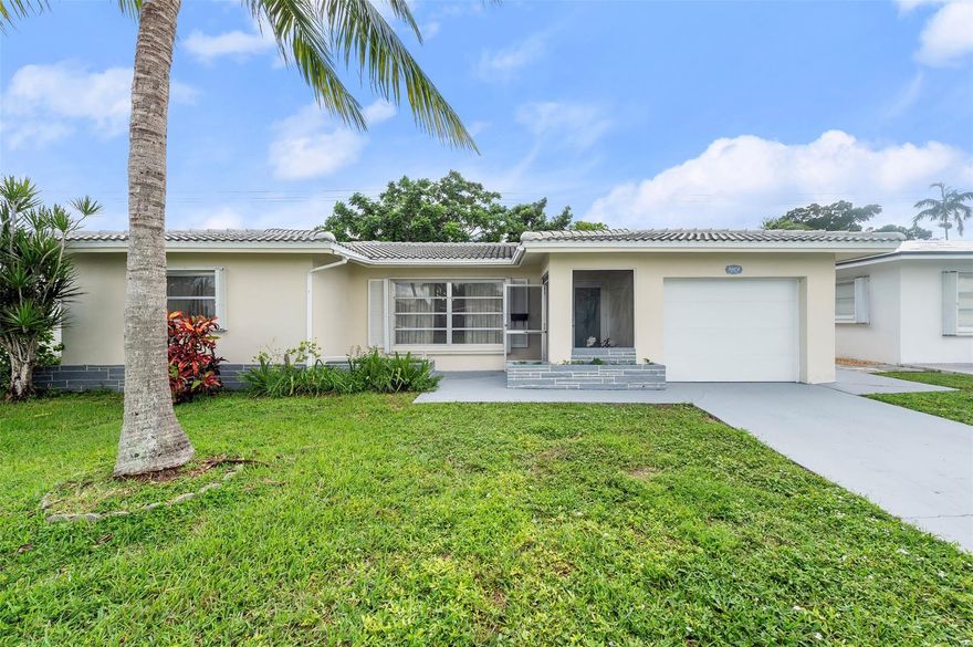 ACCEPTING BACK-UP OFFERS!! Very Motivated Seller!! Welcome to your tropical oasis! This charming 2-bedroom, 2-bath home offers comfort, space, and peace of mind with a new impact door, a newer roof (2023), and a 2023 water heater and 2023 A/C. The new garage doors and accordion shutters add extra security and value. Inside, you'll find oversized bedrooms and a spacious enclosed Florida room—perfect as a sunroom, office, or easily converted third bedroom. Enjoy indoor-outdoor living in your large backyard surrounded by lush tropical fruit trees, including mango, soursop, ackee, and June plum—a true paradise for nature lovers. Don't miss this beautifully maintained home with modern updates and endless potential!