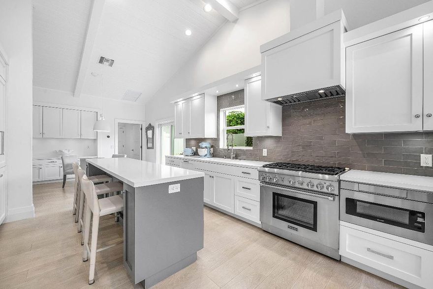 Turnkey sophisticated luxury! Unparalleled, high-end contemporary home showcasing open-concept living bathed in natural light. Serene neutral tones create an atmosphere of refined elegance throughout. The chef's kitchen features a gas range & top-tier appliances, anchoring expansive living and entertaining spaces. The primary retreat is a private sanctuary, offering dual his-and-her spa-inspired bathrooms. Step outside to a resort-style oasis with a new salt water pool & spa, sleek new pool patio, and low-maintenance artificial turf framed by lush, manicured landscaping. The coveted southern-facing backyard delivers long golf views and sun-filled days. A covered patio with phantom screens provides an exceptional extension of living space for year-round enjoyment. The exclusive Bocaire Club is limited to just 239 homes, offers exceptional resort-style amenities including championship golf, racquet sports, 24-hour fitness, fine and casual dining, social events and a warm, close-knit community. Membership extends to parents, children, and grandchildren, making Bocaire truly unique. Ideally located in an A-rated school district and just minutes from beaches, dining, shopping, and major airports, this community delivers an unparalleled South Florida lifestyle.