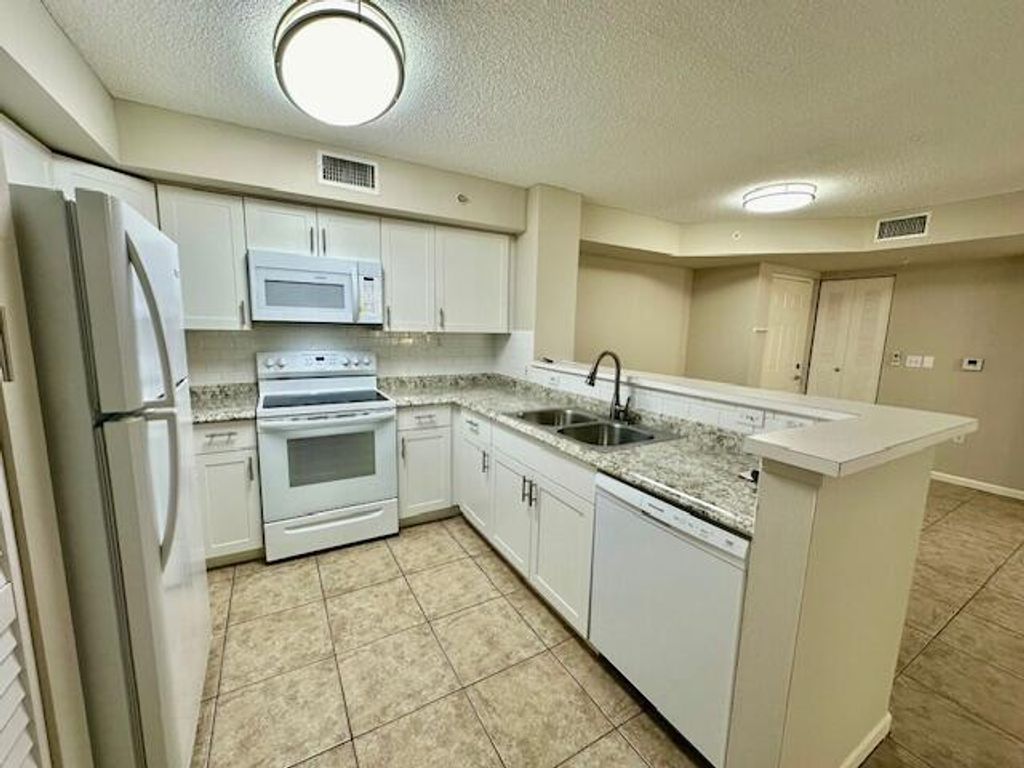 Photo of 7840 Sonoma Springs Circle #103, Lake Worth, FL 33463 (MLS # B26022563)