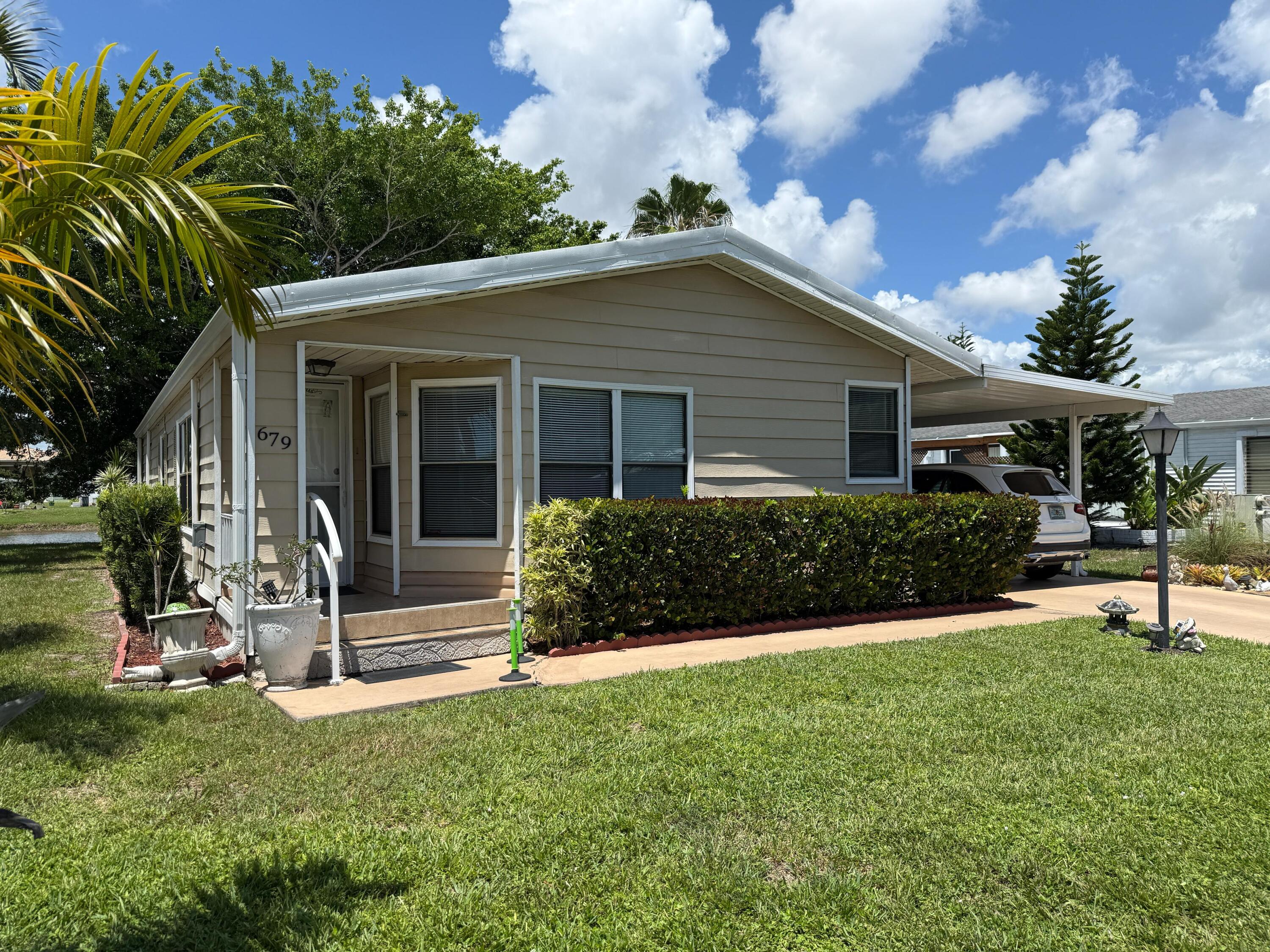Spacious 2/2 home with stunning lake views in a vibrant 55+ Boynton Beach community! This beautifully maintained property offers tile and laminate flooring, a large kitchen with plenty of counter space, and a convenient laundry room. The open layout fills the home with natural light, while the patio provides the perfect spot to enjoy peaceful lake views. Residents enjoy fantastic community amenities and a prime location close to shopping, dining, and beaches.Mobile Home Dealer License DH/1117396/1.