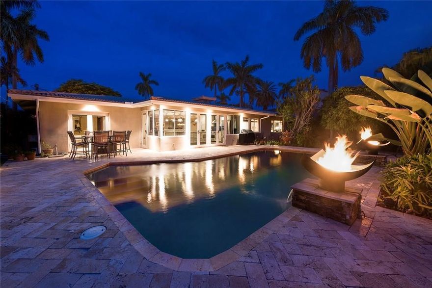 An entertainer's delight comes to life in this tastefully updated Sunrise Key Waterfront Home.  Step into this wide open Floor plan where your gourmet kitchen awaits, Wolf, Sub-zero and Kitchen Aid are a few names that greet you, Huge Island and bar give your guests a front row seat to the tropical oasis that awaits out back. 2 Tiki Huts are just a few of several relaxing spots you will find surrounding the pool with Fire pits offering dramatic ambiance. This gated island is minutes to beach and Las Olas.