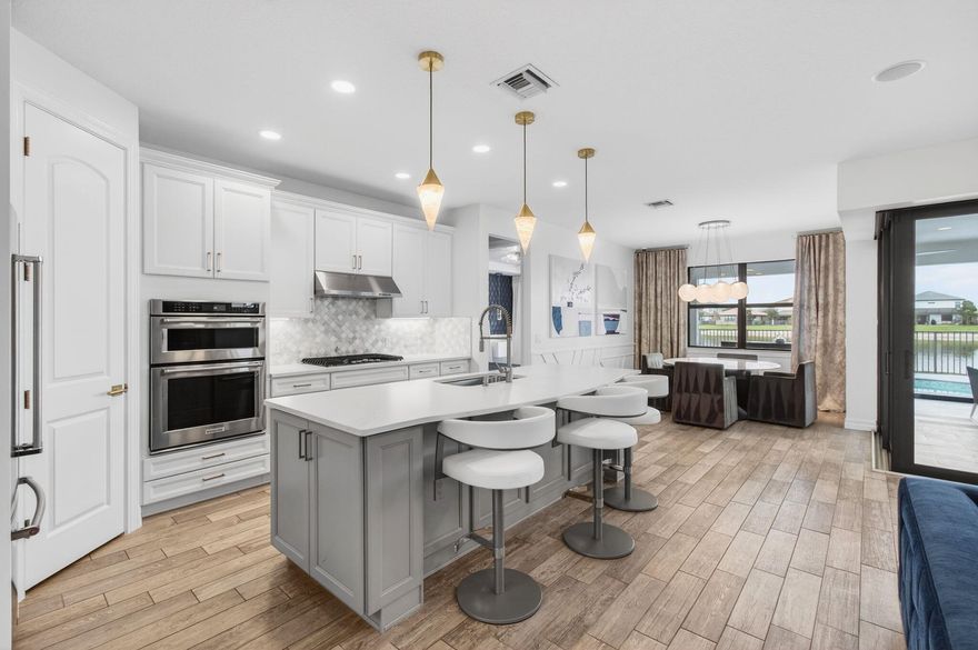 Here is your chance to live in a Spectacular waterfront residence with the highest standards of design and luxury. This 2 bdrm plus a Den home features professionally curated interiors, imported Italian furnishings and lighting and custom wall treatments. Fully upgraded kitchen offers expansive counter space, designer light fixtures and stunning lake views, creating a grand yet inviting centerpiece for the home. The home is offered Fully Furnished. The primary suite overlooks the lake and features a spa-style open shower and a custom expanded walk-in closet with built-in shelving. Heated Salt water free-form pool and spa with a covered entertaining space and electric screened enclosure. SMART home features Impact windows, including zero corner glass door; a Generac generator, Sonos audio system inside and outdoors, security cameras.
- Nestled on a premium lot, the Heated Salt water free-form pool and spa with a covered entertaining space and electric screened enclosure - your perfect backyard to enjoy the tranquil waterfront and sunset views.
- Located in an upscale gated community with resort-style amenities including modern Clubhouse, a community pool, tennis, pickleball, full size gym,basketball and more.
- Conveniently positioned near the Wellington Equestrian Center, and Palm Beach or Delray Entertainment.