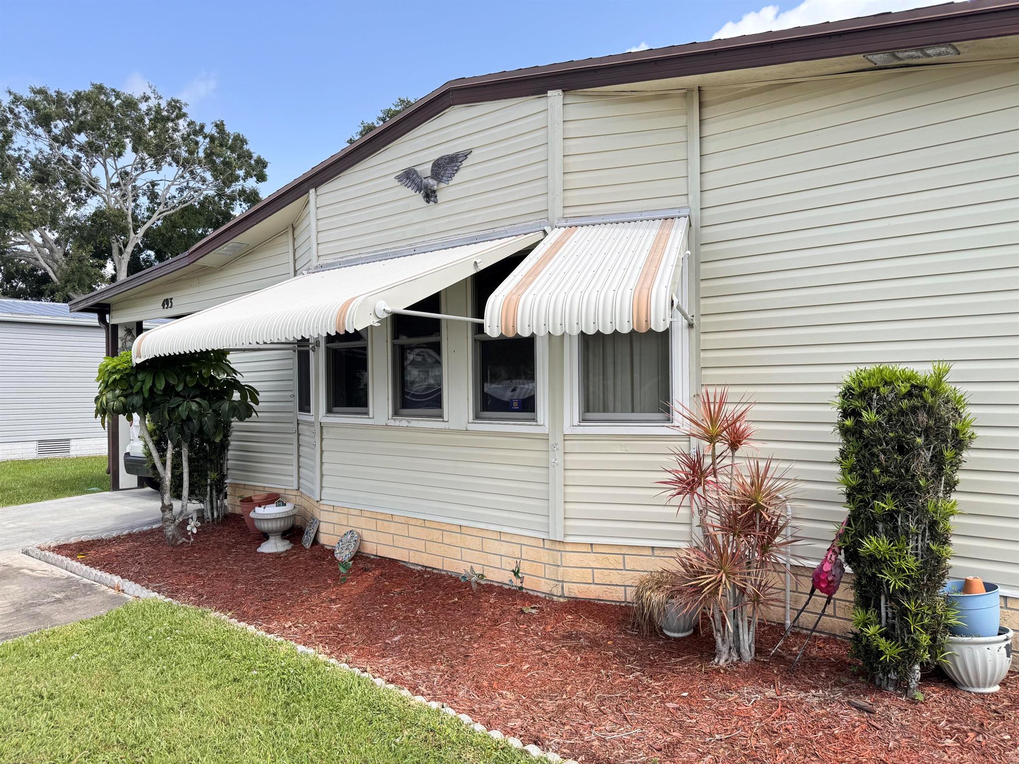 Spacious and well maintained 2 Bedroom 2 bathroom mobile home located in the desirable 55+ community of Tropical Isles. Open floor plan design with bamboo flooring, amazing Florida room, attached shed and newer A/C. Beautiful Community offers amenities such as a club house, pool and social activities. Make your appointment to see this lovely home today.