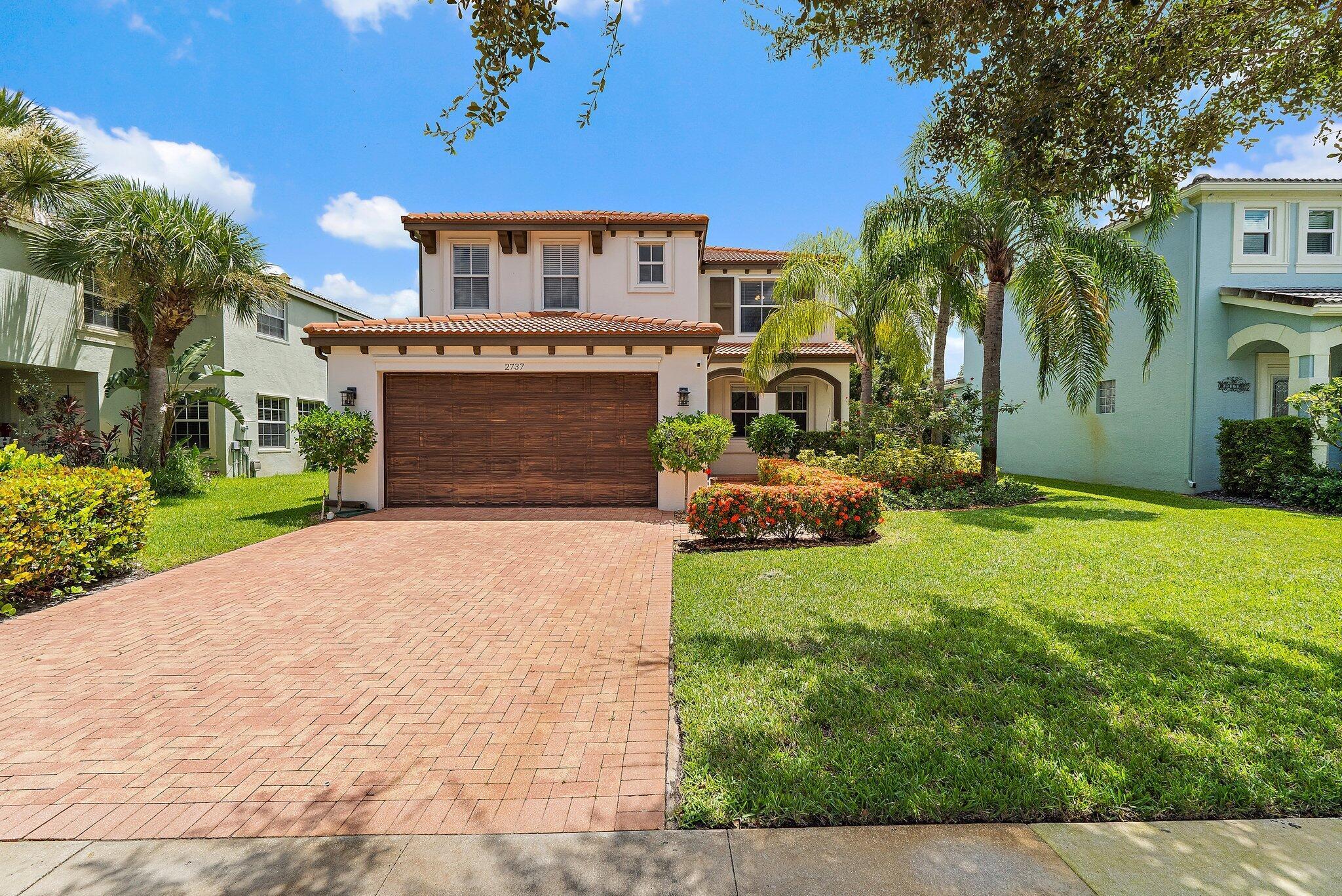 Charming sun-filled home in the heart of Royal Palm Beach! Updated exterior and interior paint, with new floors throughout and gorgeous new bathrooms inside. Large and private rear yard, plenty of room for oversized pool or enjoy the privacy and greenspace as-is. Lots of new or replaced items such as water heater, HVAC, belt-driven garage opener, lighting, etc. Equipped with 50-Amp EV charging station. Sidewalks, private streets, and amenities galore, including a fully-staffed 5,000-square foot clubhouse, state-of-the-art fitness center, billiards room, tennis, pickleball, and basketball courts, a resort style pool and spa, and splash park. Come put your stamp on this turn-key, move-in ready home.