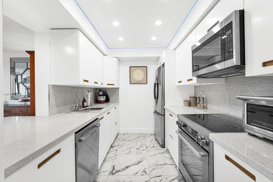 A KNOCK OUT TOP TO BOTTOM!! Smooth ceilings with hidden wires throughout, LED touch/dim recessed & accent lighting. Modern ceiling fans & beautiful Alexa Intelligence custom programmable electric shades. 24" x 24" Calcutta Spanish white porcelain tile with accent veining throughout the condo.  All white kitchen cabinets, white quartz countertops, undermount sink, wave motion faucet, top of the line stainless steel appliances & breakfast bar open to  living area. Custom coffee counter niche with pantry & wine cooler. Both bathrooms completely remodeled with white on white vanities & quartz countertops, sparkling chrome fixtures, lighted & heated mirrors (no fog!), frameless glass shower & Hi Tech auto flush commodes, one with bidet!  Murphy bed in 2nd bedroom. Ring system, covered balcony, sunny and bright Southern exposure and view of the fountain and boats on the canal.  Available furnished or unfurnished.  A MUST SEE!!   Gated waterfront private island with 24 hr manned guardhouse, 3 heated pools, tennis/pickleball courts, fitness center and kayak/paddleboard racks.  2 small pets -20 lbs each permitted, dockage to 50' as available at only $48.90 per foot per year!  Great central location just minutes to Las Olas/downtown, beaches, restaurants, shopping, performing arts, library, Port, airport and all major expressways!