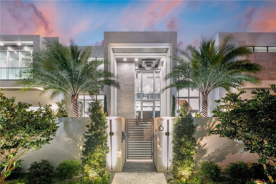 Set in the prestigious Seven Isles, this luxurious contemporary 2023 masterpiece w/breathtaking Intracoastal views showcases 12,336 sf of exquisite detail & refined finishes with a rare 120' of WF. As you enter, revel in the bright natural light illuminated by floor to ceiling windows. Main level hosts a spacious living area with a two-floor feature wall like no other, glass wine wall, lounge & gourmet chef's kitchen, pantry & prep kitchen. Find a stunning 4 car show case garage w/ AC's for car fanatics. Follow the floating staircase to 2nd floor and live in luxury in the expansive primary suite that includes an elegant showroom-style custom wardrobe room. The backyard oasis boosts a 72' lap pool & built in summer kitchen. Experience a real life getaway from the comfort of your own home!