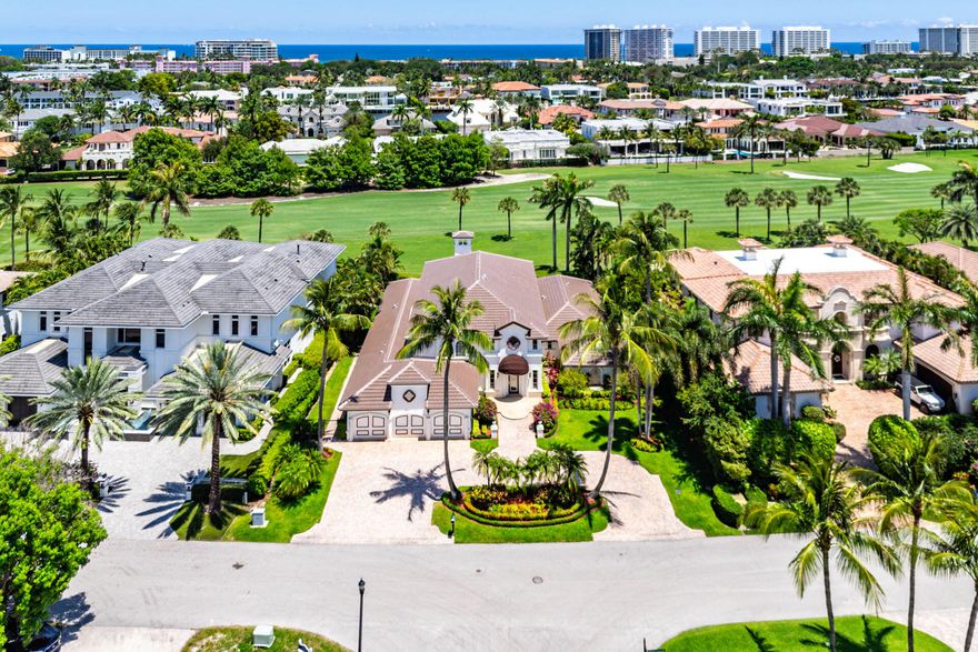 Welcome to 1330 Sabal Palm Drive, perfectly positioned on the Royal Palm Yacht & Country Club's acclaimed golf course. Designed for seamless indoor-outdoor living, this residence captivates with clean architectural lines and thoughtful details.
A dramatic front exterior sets the tone, framed by lush landscaping and elegant architectural accents. A grand double-height foyer with statement lighting opens to an expansive living area with natural light, with floor-to-ceiling windows showcasing sweeping golf course views. An elegant dining room complements the home's flow, while a stylish den with an intimate wet bar offers the perfect space for entertaining or relaxing with friends. The luxurious primary suite is a private retreat with a spa-inspired bathroom, a soaking tub, a walk-in shower, and uninterrupted fairway views. Outdoor living takes full advantage of the setting, featuring a resort-style pool, covered patio, outdoor kitchen, and manicured grounds that flow seamlessly to the course. Additional highlights include spacious guest suites and a home office/flex space. This exceptional home offers a rare opportunity to enjoy contemporary sophistication and effortless Florida living in a prime golf course location.