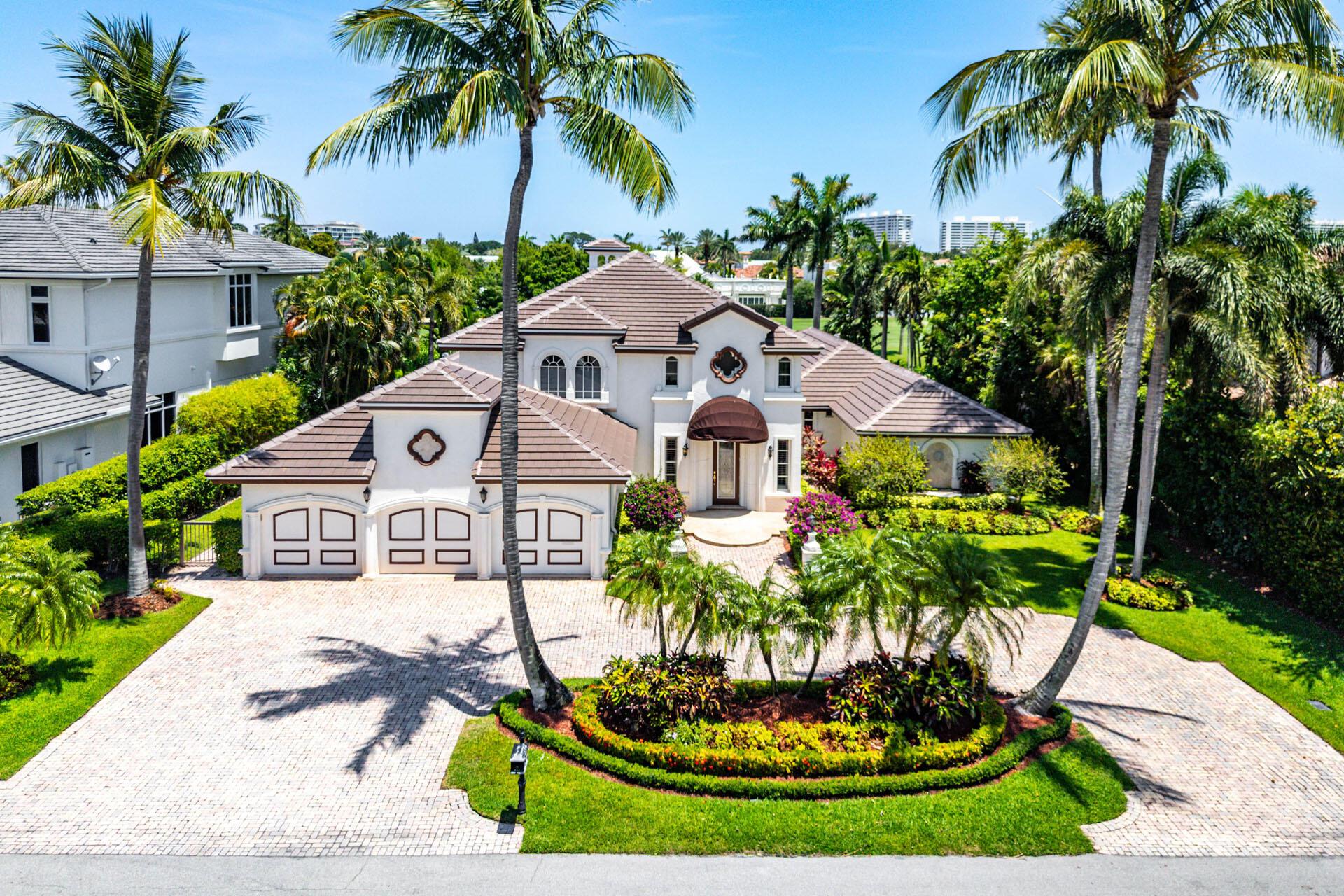 Welcome to 1330 Sabal Palm Drive, an exceptional contemporary estate that blends modern luxury with timeless elegance, perfectly positioned on the Royal Palm Yacht & Country Club's acclaimed golf course. Designed for seamless indoor-outdoor living, this residence captivates with clean architectural lines and thoughtful details.A dramatic front exterior sets the tone, framed by lush landscaping and elegant architectural accents. A grand double-height foyer with statement lighting opens to an expansive living area with natural light, with floor-to-ceiling windows showcasing sweeping golf course views.