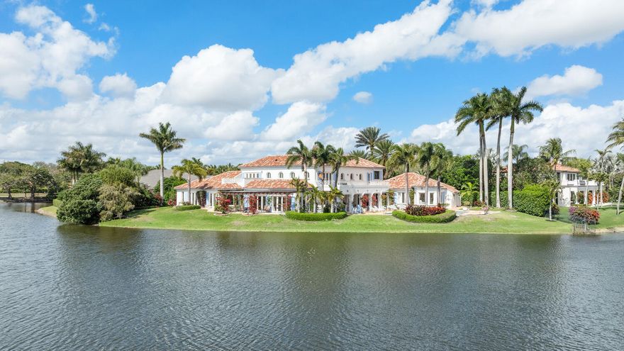 Located within the exclusive enclave of Fairway Island inside the prestigious Palm Beach Polo & Country Club, this estate is situated on over half an acre lot with breathtaking water views. This impressive waterfront property features 6 bedrooms and 6.5 bathrooms, including a private in-law suite ideal for extended family or guests. Designed with comfort and entertaining in mind, the expansive floor plan includes generous living areas, high ceilings, and large windows that fill the home with natural light while showcasing the surrounding water. Outdoor living is just as inviting, with a large heated pool, an extended patio perfect for gatherings, and serene waterfront scenery that provides stunning sunsets.
