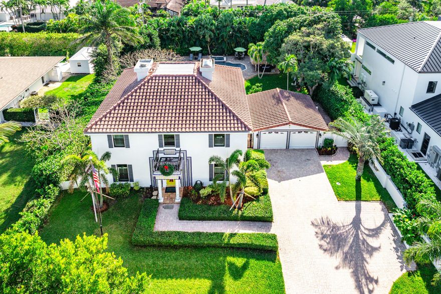 Rare Beachside Gem in Ocean Ridge - Timeless Charm, Modern Living. Welcome to your private slice of paradise in Ocean Ridge—one of South Florida's most charming, exclusive seaside towns and one of its best-kept value secrets. This beautifully updated coastal retreat is just steps from the beach with deeded private access, offering the laid-back elegance of Old Florida with all the comforts of today.
Behind a secure electronic gate, a brick-paved drive leads to a detached two-car garage and a welcoming entry framed by Mediterranean columns and custom tile details. Inside, light-filled spaces flow effortlessly from the foyer into an open-concept layout featuring new solid wood floors, crown molding, and solid interior doors throughout. The spacious family room is warm and inviting, centered around a fireplace, with imported tile detailing, and framed by impact glass doors that open to an expansive backyard and patioperfect for indoor-outdoor living.
The kitchen is designed for both style and entertaining, with expansive quartzite countertops, custom wood cabinetry, a breakfast bar, and top-tier stainless steel appliances, including a commercial gas range and striking Mediterranean mosaic backsplash. A formal dining area sits just steps away, ideal for easy gatherings with family and friends.
This five-bedroom, three-and-a-half-bath home offers flexibility and comfort. A downstairs guest suite with ensuite bath and adjacent bonus room works beautifully as a home office, den, or optional fifth bedroom.
Upstairs, the primary suite is a true retreat, complete with a sitting area, two walk-in closets with custom shelving, and dual spa-like bathroomsone featuring a soaking tub, steam sauna shower, dual vanities, and bidet; the other offering a tub/shower combination and spacious vanity.
Step out onto the large tiled balcony and enjoy serene views of lush tropical gardens and a tranquil fountain. The outdoor living spaces are exceptional: a covered patio with tongue-and-groove wood ceiling, Mediterranean tile accents, graceful arches, a fire pit conversation area, and a thatched tiki hut beside the custom pool and spaall surrounded by brick pavers.
Located less than a block from your private deeded beach path, this home offers miles of pristine shoreline just outside your door. Enjoy the peaceful, intimate feel of Ocean Ridge while being minutes from world-class dining, shopping, Boca Raton, Worth Avenue, and Palm Beach International Airport.
A true coastal lifestyle homechic, relaxed, and an incredible value in one of South Florida's most beloved beach towns.
