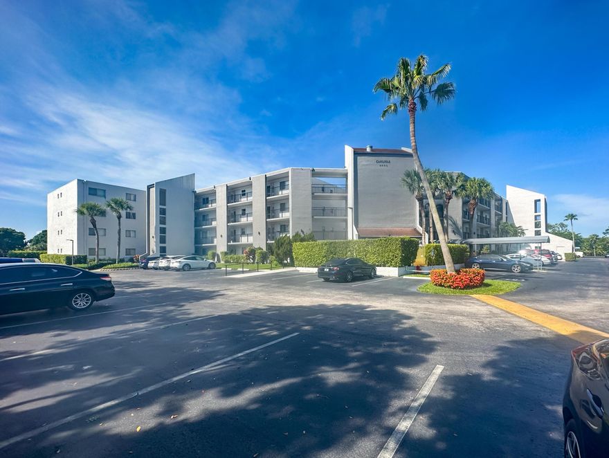 WELCOME TO THIS NATURALLY BRIGHT CONDO WITH SOUTH FACING BALCONY VIEWS OF THE GOLF COURSE, POOL, LAKE, & FOLIAGE . THIS CORNER CONDO HAS LARGE TILED FLOORING, AN EXTRA WINDOW IN THE KITCHEN, SPACIOUS ROOMS , LOTS OF CLOSET SPACE & AN UPDATED KITCHEN WITH STAINLESS APPLIANCES. IT IS CONVENIENT TO THE ELEVATOR AS WELL & MOVE-IN READY (SMALL SOFA IN GUEST BR EXCEPTION). THE CARLISLE BUILDING HAS 2 UPDATED ELEVATORS, A POOL AT THE BUILDING & AN UPDATED ROOF (2022). THERE IS ANOTHER POOL AT THE CLUBHOUSE WITH PICKLEBALL, TENNIS, GOLF (PAY-AS-YOU-PLAY), GYM, MEL'S BISTRO & ENTERTAINMENT, CLASSES & MORE! CONVENIENTLY LOCATED WITHIN MINUTES TO THE TURNPIKE, SHOPPING, RESTAURANTS & APPROXIMATELY 8 MILES TO THE BEACH. 55+AGE COMMUNITY WITH LOTS TO ENJOY! MAKE THIS YOUR HOME IN THE SUNSHINE!