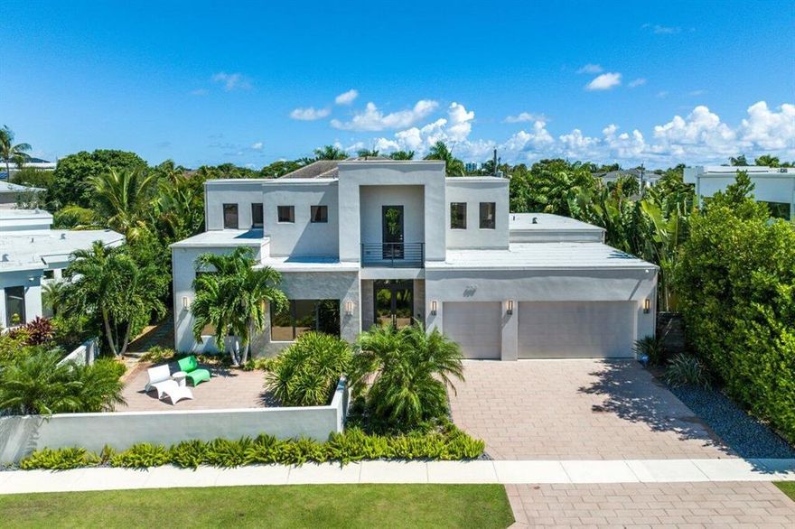 One of the best locations in the Golden Triangle! This newer construction, warm contemporary home is less than a block to Mizner Park, and walking distance to the best of Boca Raton! Open and spacious, this custom designed plan features a wide-open living space with two-story ceilings, a first-floor primary suite, expansive closet and views of a tropical backyard. Specifically designed with entertaining in mind, with an extra-large dining area, den, enormous pantry and more. First floor features primary suite & office (or bed #5), with three king-sized suites upstairs. The backyard is ultra-private, with sparkling salt-water pool & spa, built-in grill, and low maintenance landscaping. A unique front patio is perfect for welcoming guests and enjoying the sights and sounds of Mizner Park!