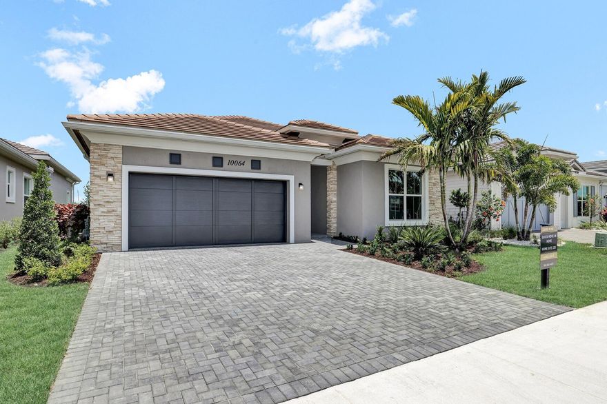 This McKenna home is stunning, boasting a striking Contemporary elevation with sophisticated veneer stone exterior that sets the tone for elegance. As you enter, you're welcomed by a coffered foyer with soaring ceilings, leading to an expansive 3-bedroom, 3-bathroom open-concept floorplan designed for both comfort and style.The entire home is adorned with exquisite porcelain tile flooring, providing a seamless flow throughout. The kitchen is a true standout, featuring quartz countertops, pantry, and upgraded appliances -- perfect for entertaining family and friends.Step outside onto your expanded covered lanai with luxurious in-ground spa, offering the perfect setting for relaxation. Located in Regency at Avenir, a manned-gate 55+ active adult community with large private clubhouse.