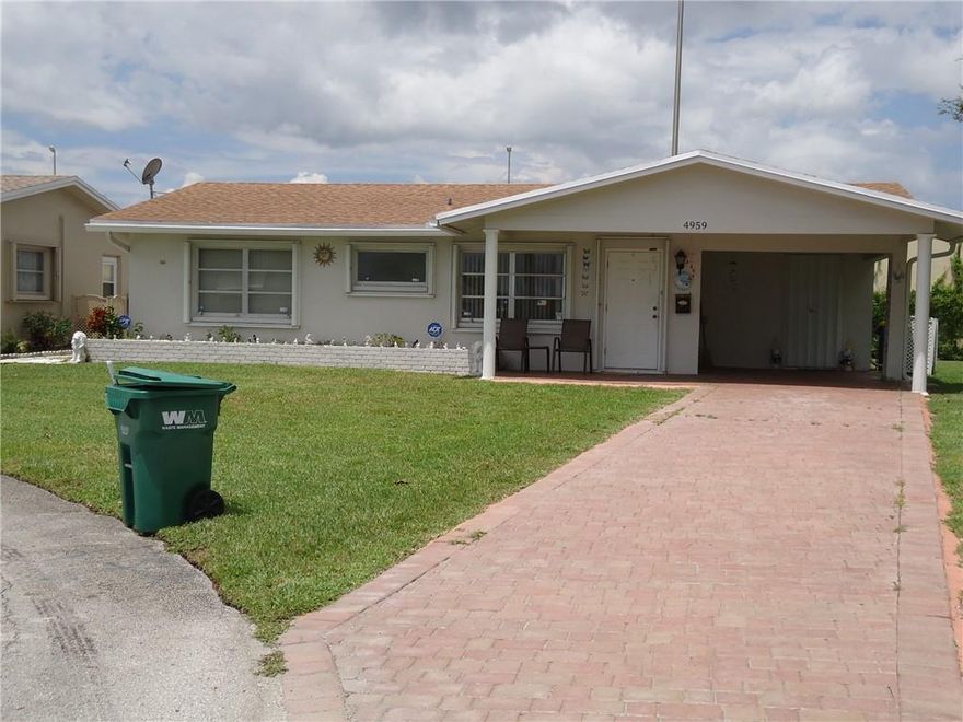 Large Corner 2 Bedroom / 2 Bath Single Family Home in a 55+ Community. Newer Roof - Newer AC/ Newer Washer & Dryer/ Newer Kitchen with Wood Cabinets. Carport with an Extra-long Driveway. Located near the Community Pool and next to a large community grass area with beautiful trees, lots of shade, and open space.