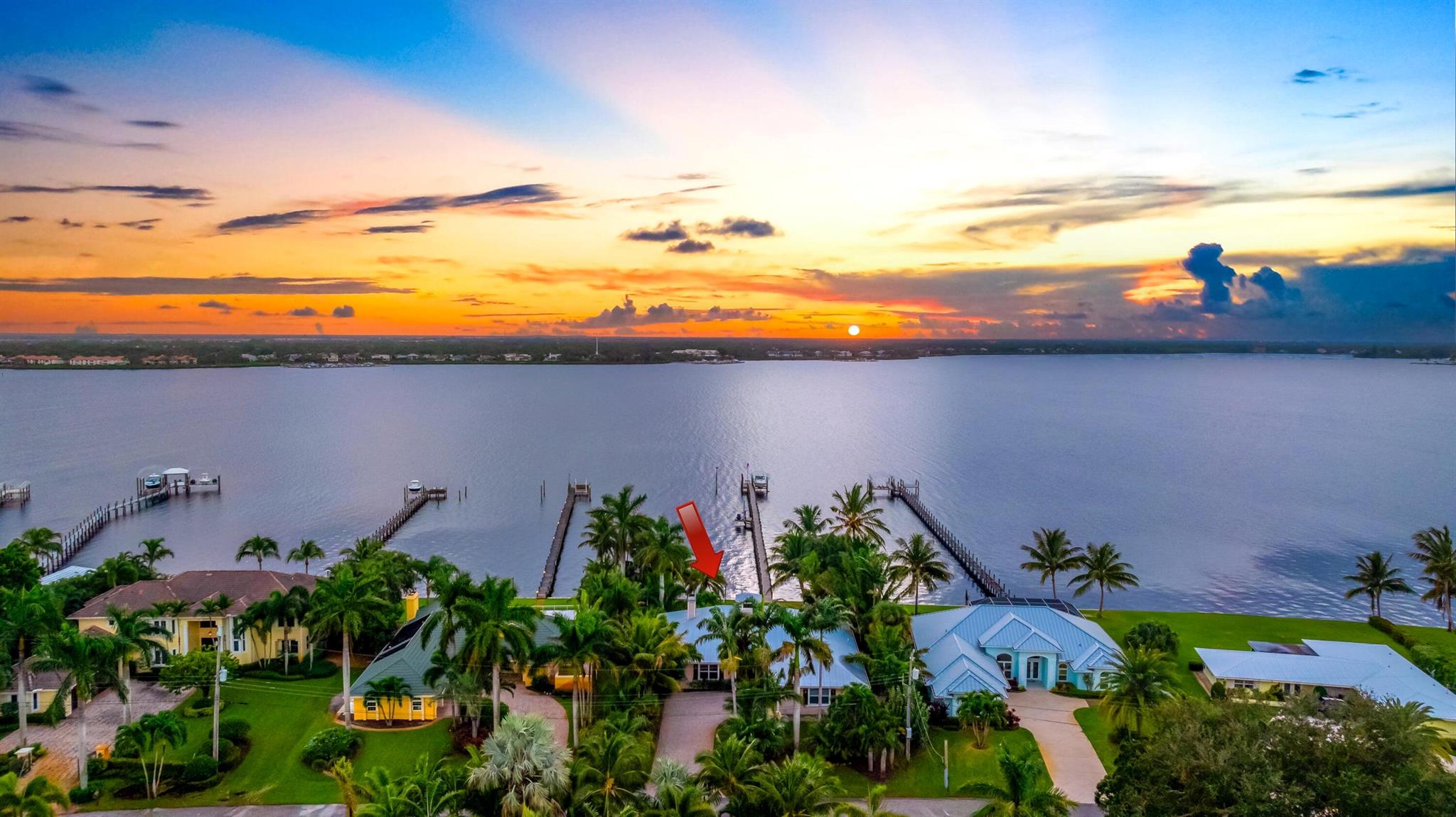 Stunning 4BR + den / 3BA Key West-style waterfront estate in prestigious Beau Rivage, offering panoramic water views throughout and breathtaking sunsets over the St. Lucie River. Deep-water access with private dock and lift enhances the home's coastal elegance. Features include a gourmet gas kitchen, spacious living areas with fireplace, and a primary suite with spa bath and walk-in closet. Outdoor living boasts a resort-style pool, spa, summer kitchen/bar, and lush tropical backyard with mature palms. Oversized 3-car garage. Prime location near US1, shopping, dining, and beaches. Call us today for your private tour!