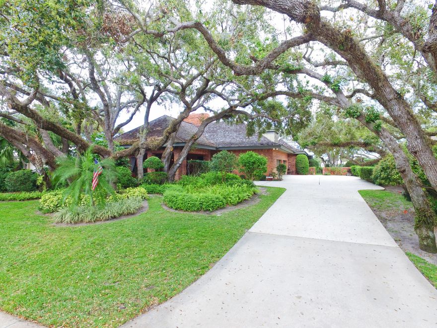 420 Coconut Palm Rd SummaryTucked away on John's Island Sound on the back side of the Indian River. One of the first homes built on "the Island at John`s Island", with such amazing and expansive water views, this home is truly unique, built with reinforced sturdy I beam custom construction. The Chicago Brick home exterior invites you through a double door entry into the foyer allowing you to witness a truly stunning open floor plan.  Take in the magnificent brick fireplace and genuine oak flooring.  Enjoy gatherings in the spacious family room as the beautiful natural lighting enhances the stunning oak vaulted ceilings. Show off your collectables a bit as there are 2 four car custom garages showcased behind custom etched sliding glass doors on both sides of the house comple