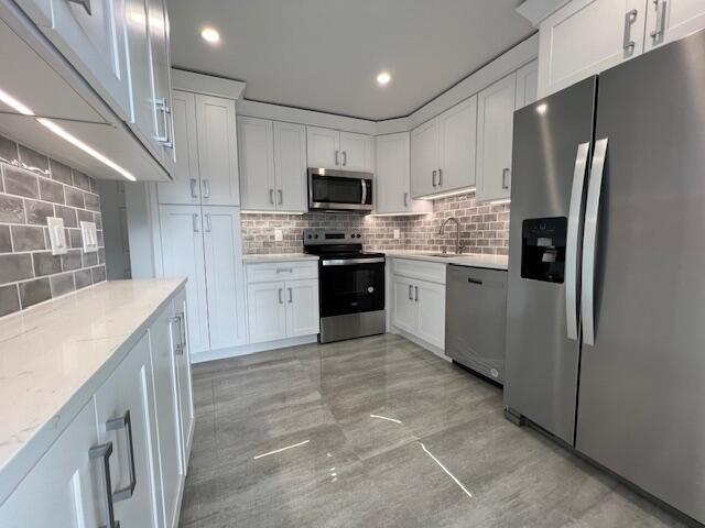 Completely ''STUNNING'' updated villa in a fantastic Boca Raton location, has been completely renovated, all-ages community. Features a brand-new kitchen with NEW stainless-steel appliances and designer lighting throughout. Beautiful new tile flooring runs seamlessly through the home. The spacious primary suite includes a brand-new, stunning bathroom and a walk-in closet. The second bedroom also boasts a brand-new bathroom. Enjoy two fenced-in patios for outdoor living and a dedicated laundry room with a full-sized washer and dryer. The unit also includes a carport. IMPACT HURRICANE WINDOWS AND SLIDINGS DOORS. Basic Cable & Internet included. Centrally located, near excellent schools, shopping, restaurants, & highways. MUST SEE!!!